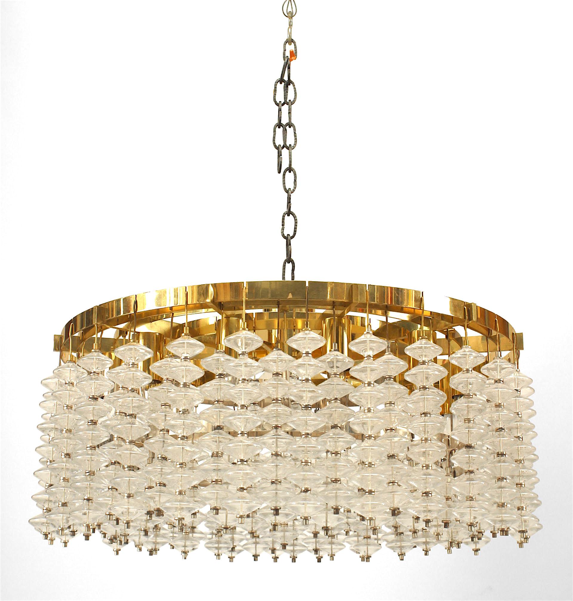 Italian chandelier 'modern' whose brass frame forms five concentric circles from which rods adorned with bubble form glass balls emanate in vertical suspension.

Priced each, two chandeliers left.

