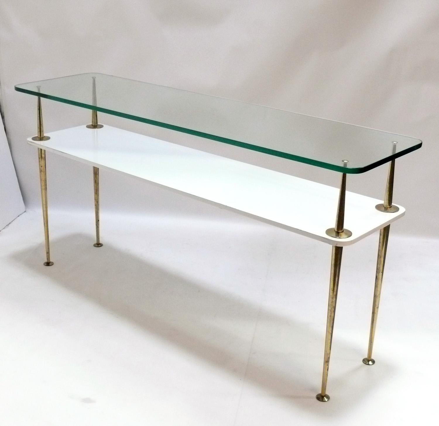 Large scale Italian console table, in the manner of Gio Ponti, unsigned, Italy, circa 1950s. This piece is a large scale, versatile size and can be used as a console table, bar, media table, or sofa table. The brass or brass plated metal legs retain