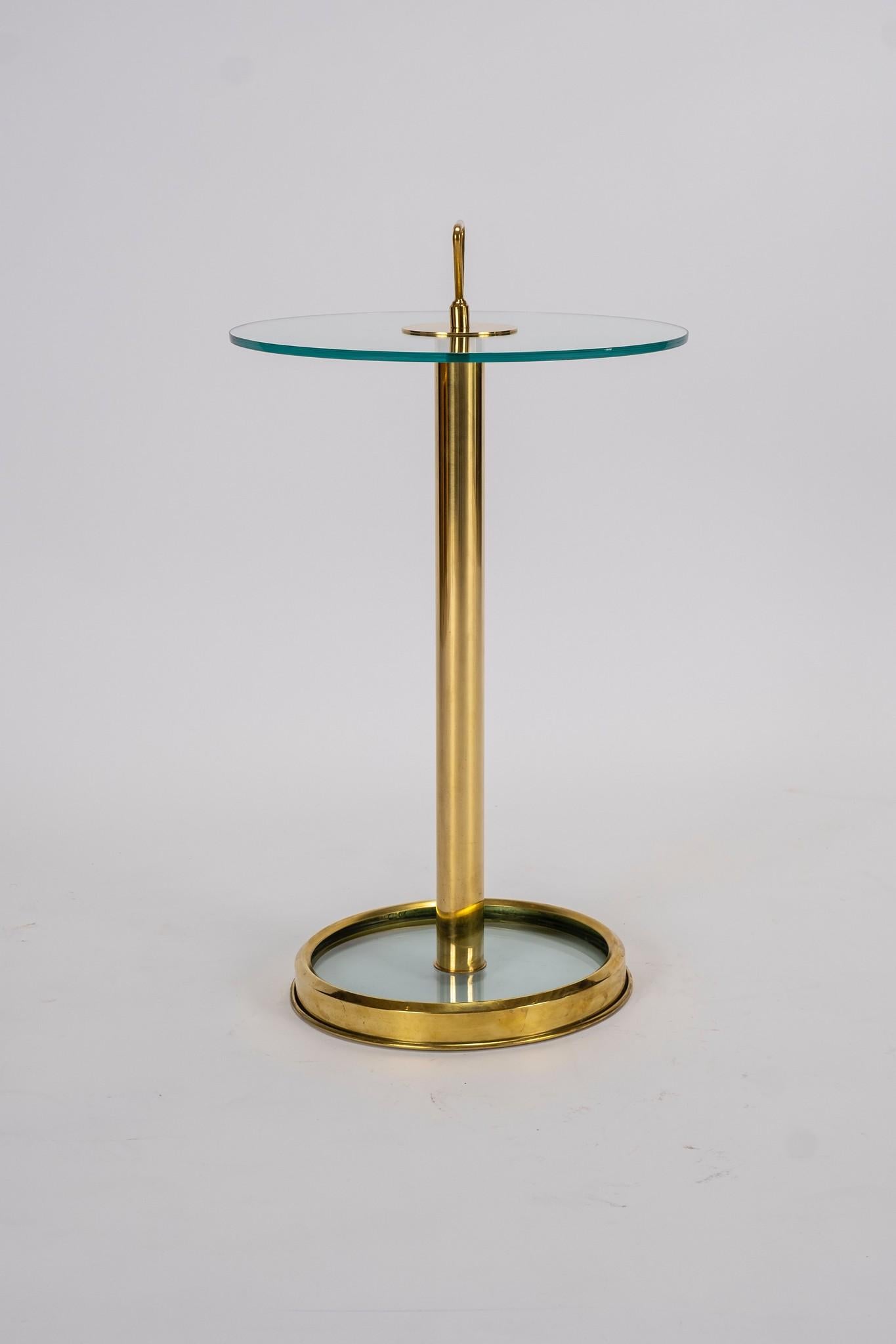 A contemporary Italian brass and glass occasional table. Glass top and at base also.

Measures: Overall height is 29