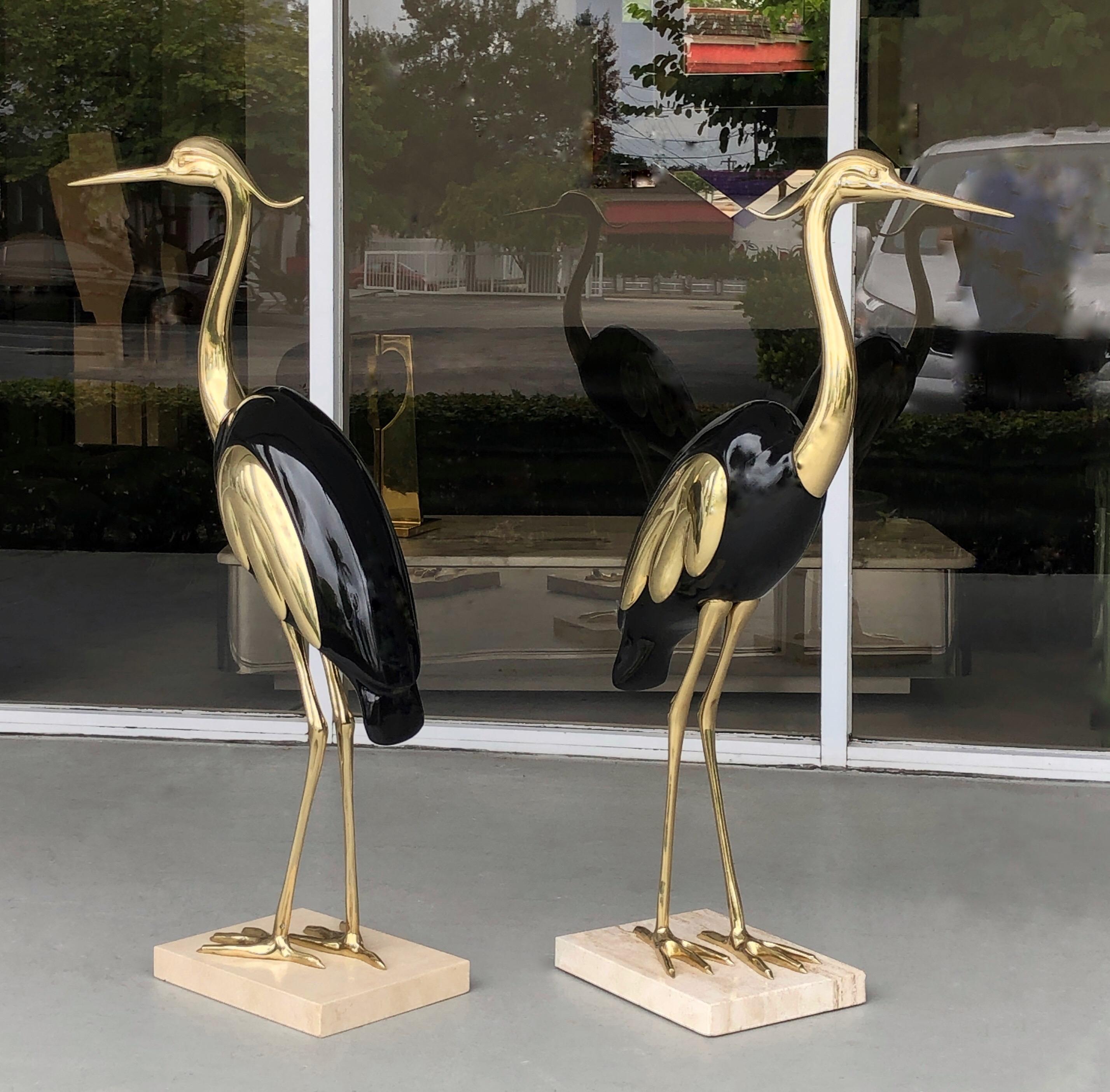 A pair of brass and lacquer bird sculptures, Italy, 1970s. Both on marble bases.