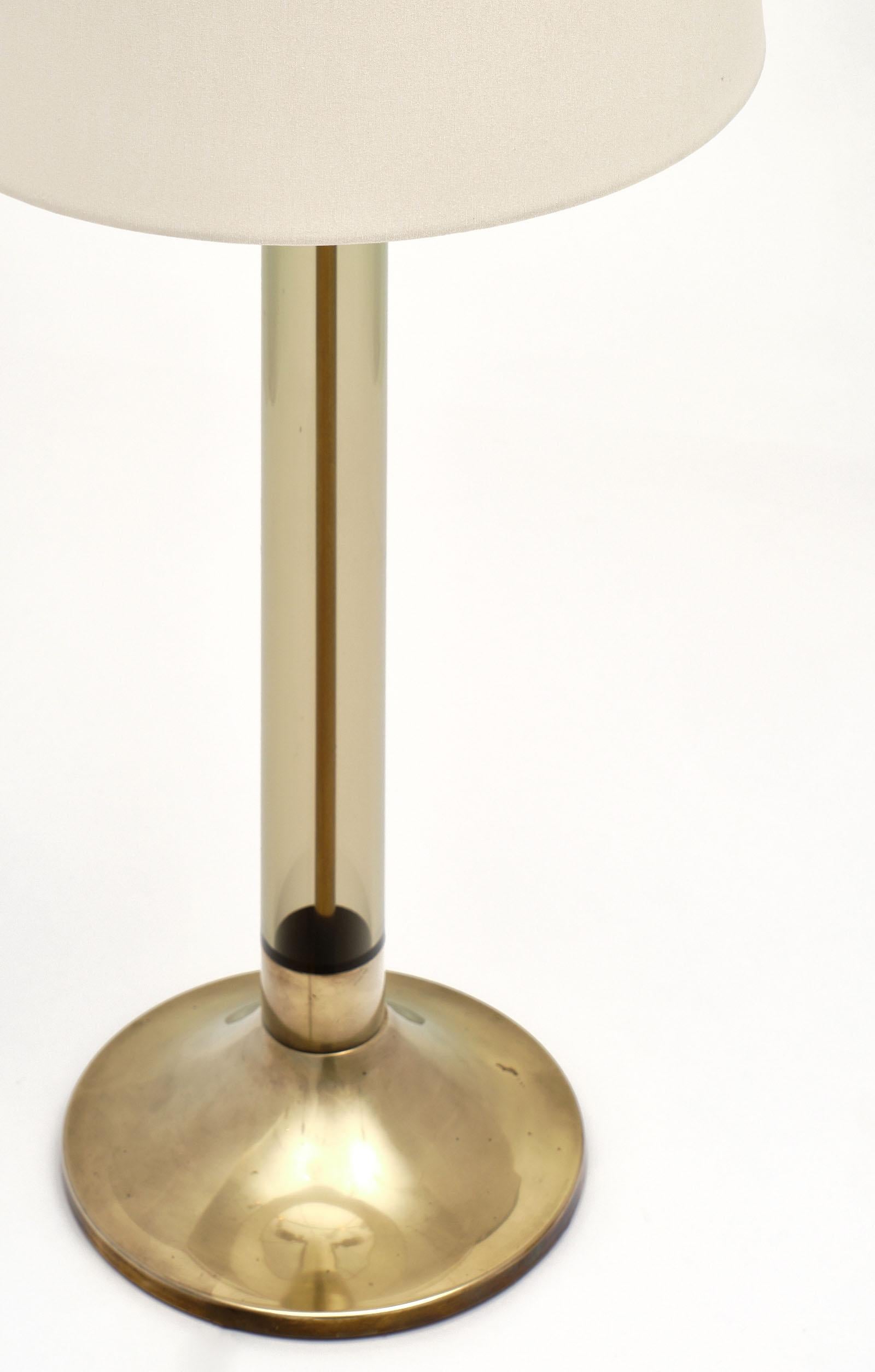 Midcentury Italian brass and Lucite lamp from Turin, Italy. This piece has a beautiful brass base with a smoked Lucite body. It requires two medium light bulbs and has been newly wired to US standards.