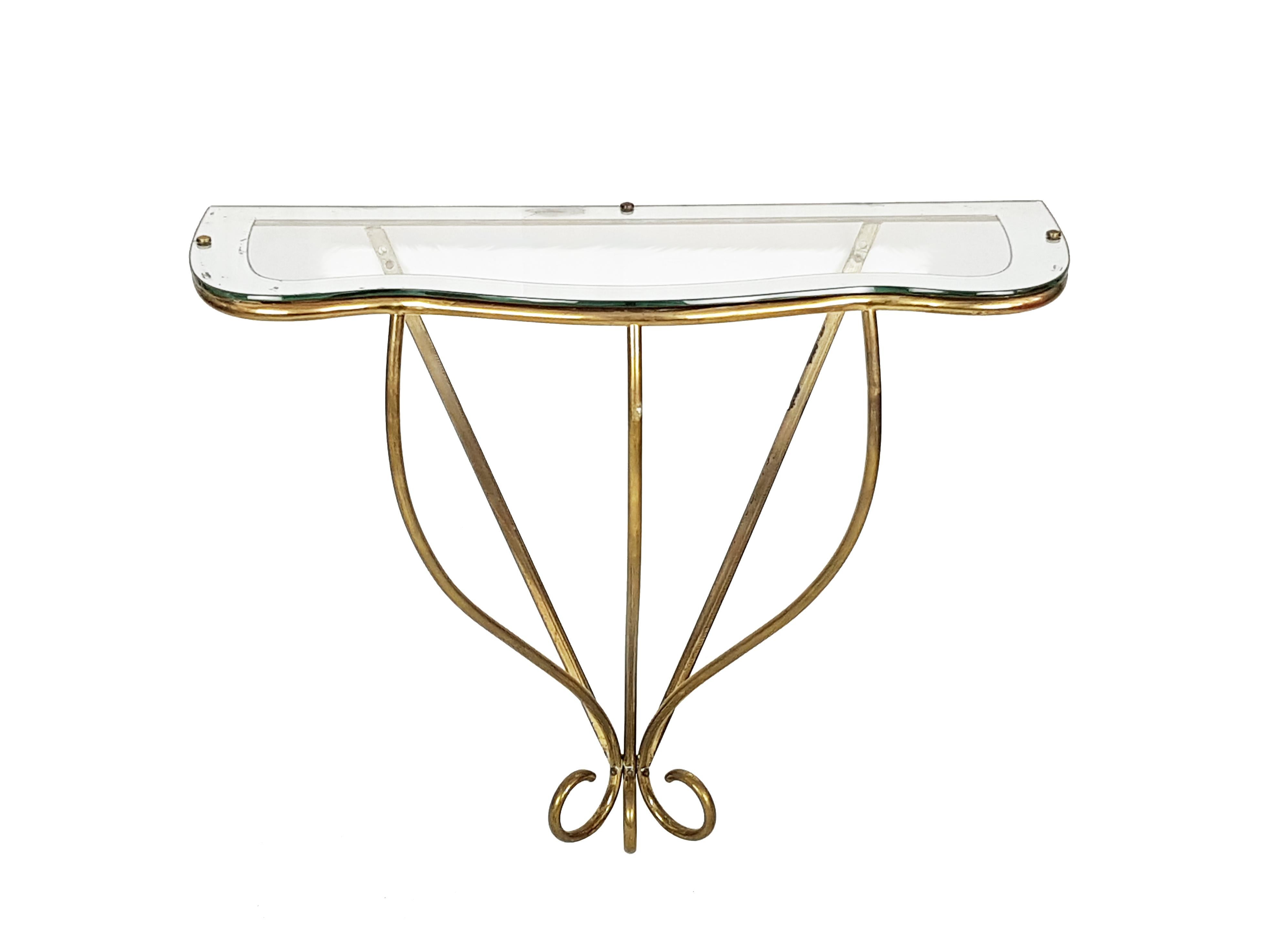 This small console was produced in Italy, circa 1950. It is made from a brass shaped rod structure with a mirrored glass top. It remains in good condition: normal brass oxidation and visible defect on the top mirrored frame as showed in picture.