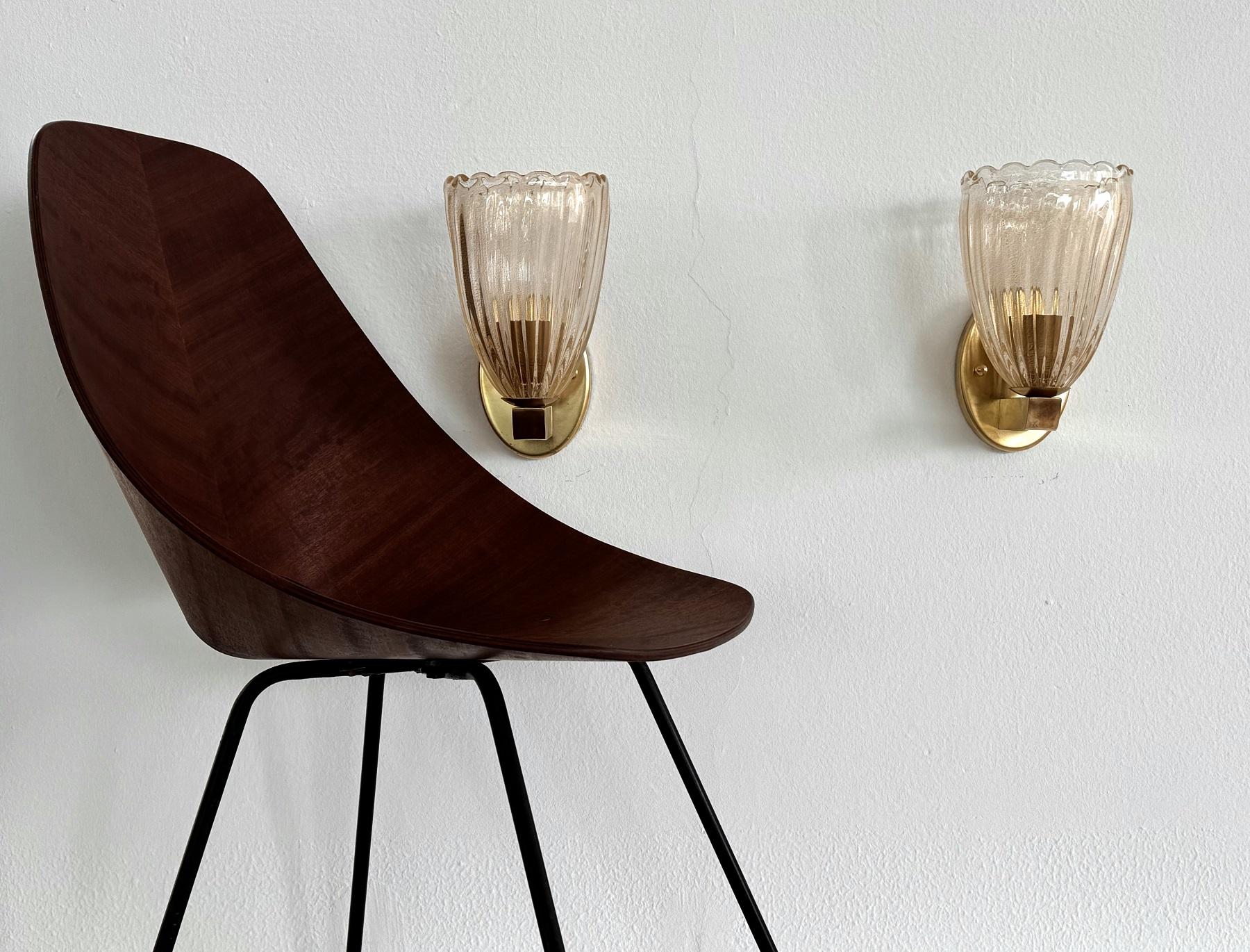 Italian Brass and Murano Glass Wall Lights or Sconces in Art Deco Style, 1990s

Beautiful set of two gorgeous brass wall lamps made of strong brass base and light amber colored Murano glasses with golden shimmer/glitter inside the glass. Art Deco