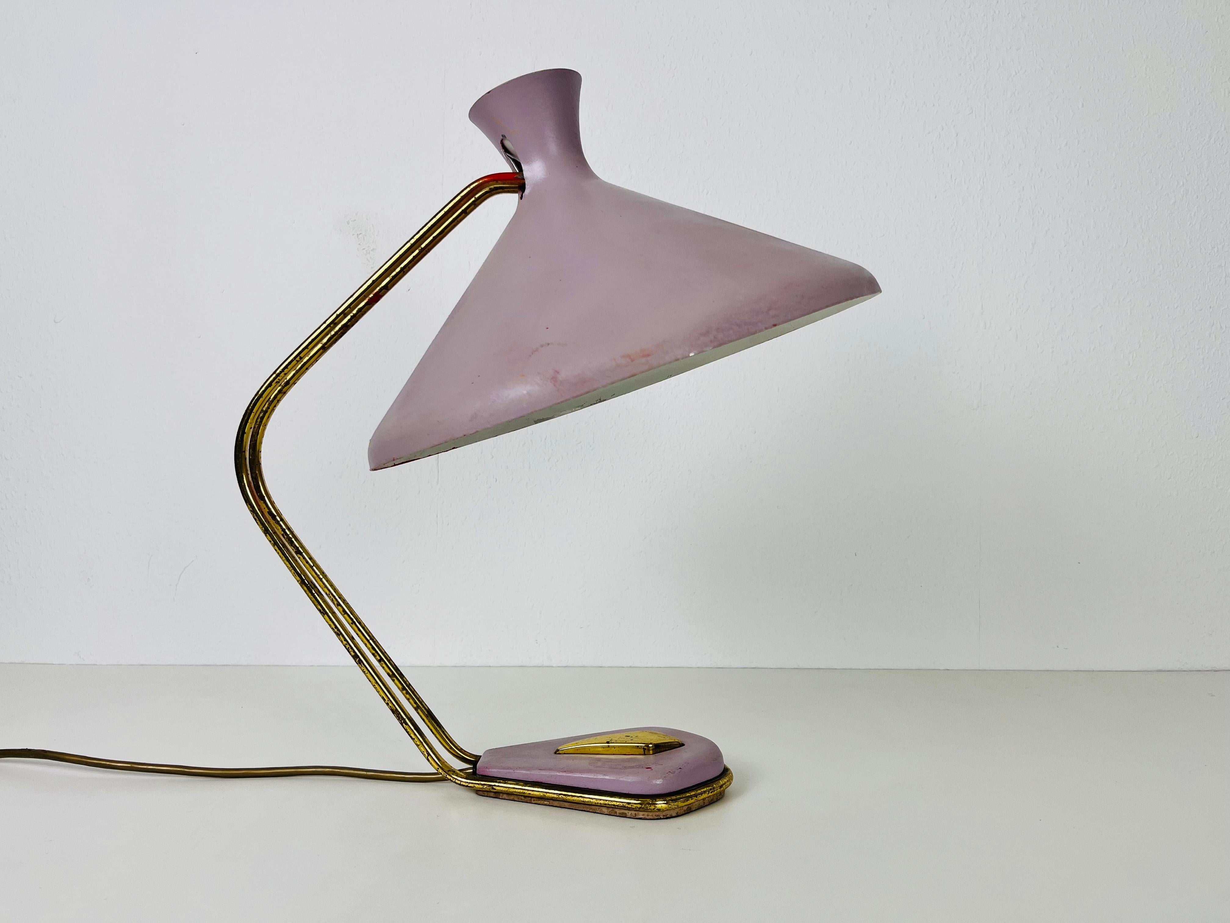 Une lampe de table italienne fabriquée dans les années 1960. L'éclairage a un design exceptionnel qui ressemble aux lampes de table fabriquées par Stilnovo. Il est fabriqué en laiton avec un bel abat-jour en métal.

La lampe nécessite une ampoule