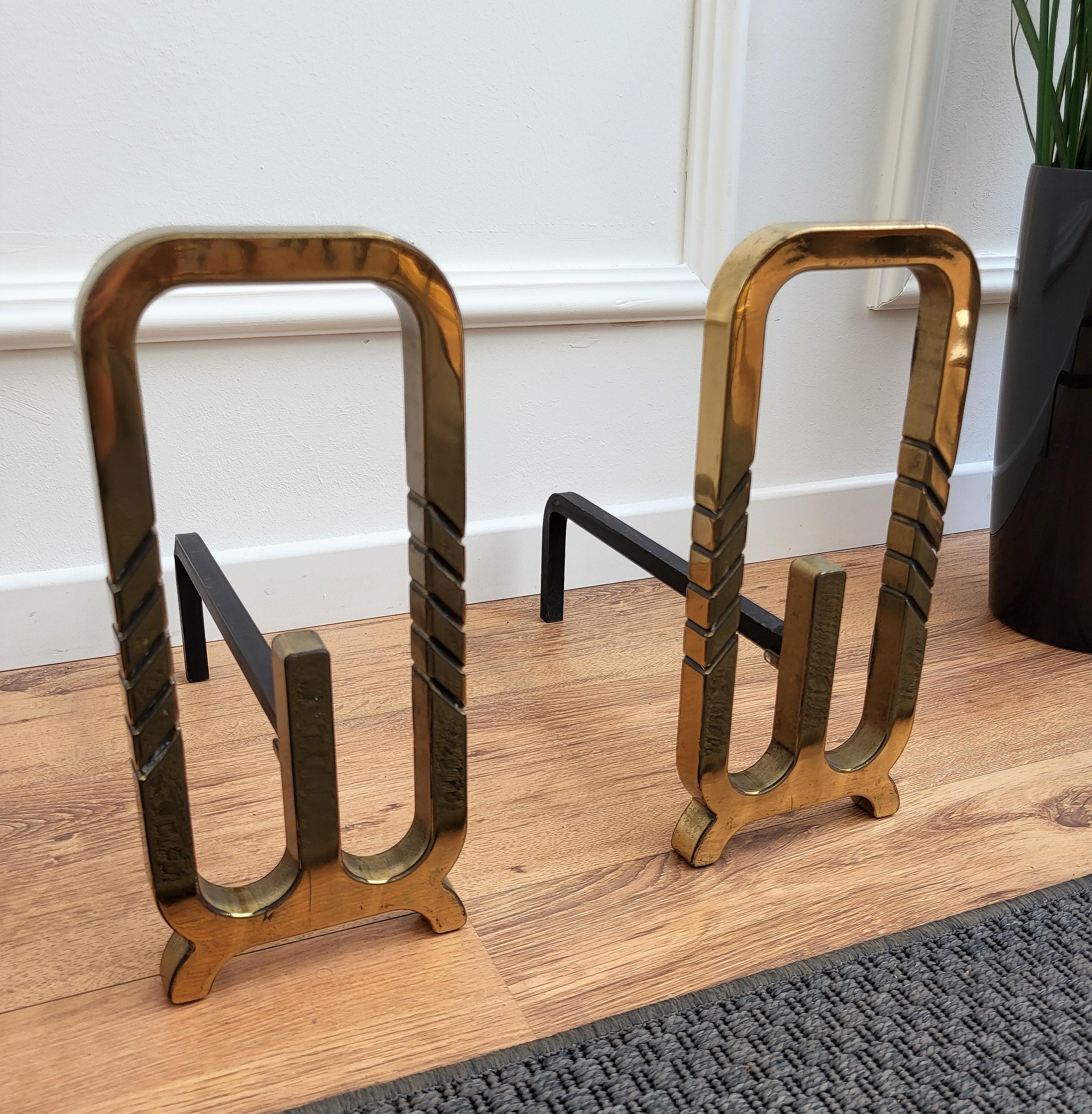 Pair of Italian brass andirons, having the usual back in wrought-iron pillars with the brass front in beautiful shape with three stripes decor detail. We do have available in the same decor the other fire place pieces, the fire screen and the tool