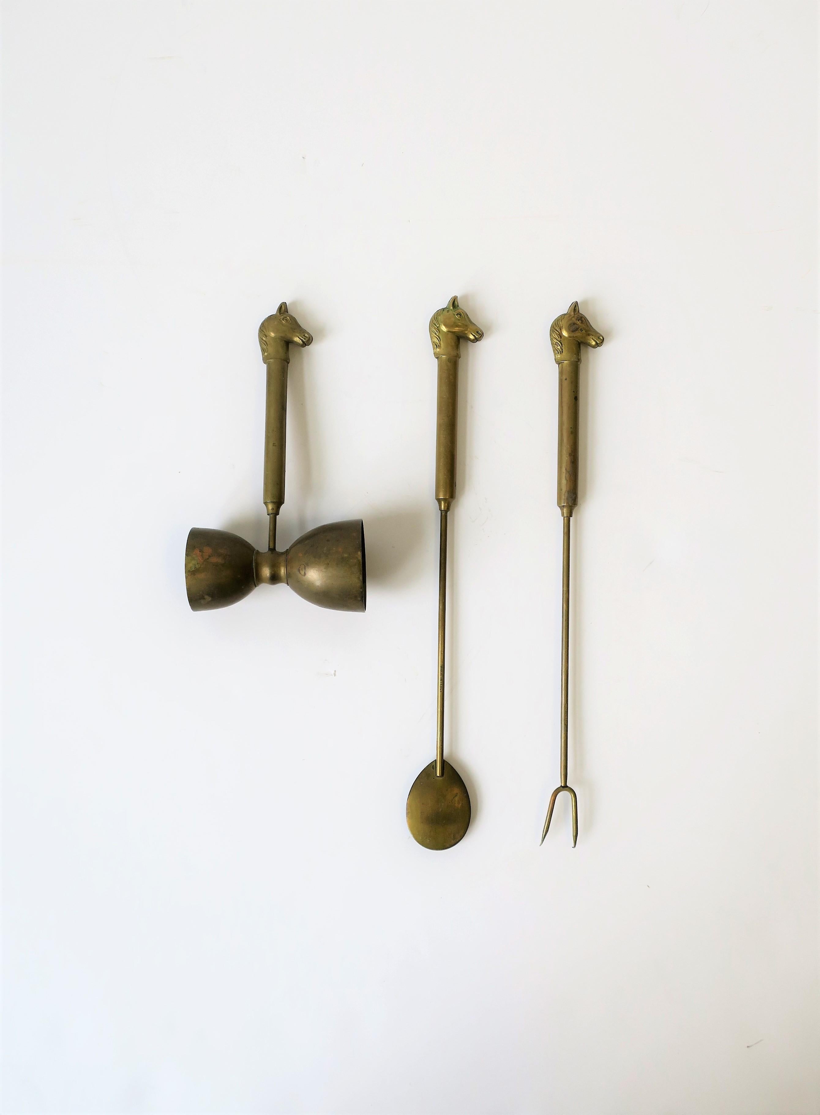 A substantial and well-made 3 piece set of Italian brass barware tools circa mid-20th century, Italy. This three (3) piece bartender tool set includes: a two-sided hourglass-shaped measuring device, aka as a jigger or shot glass, and olive, onion,