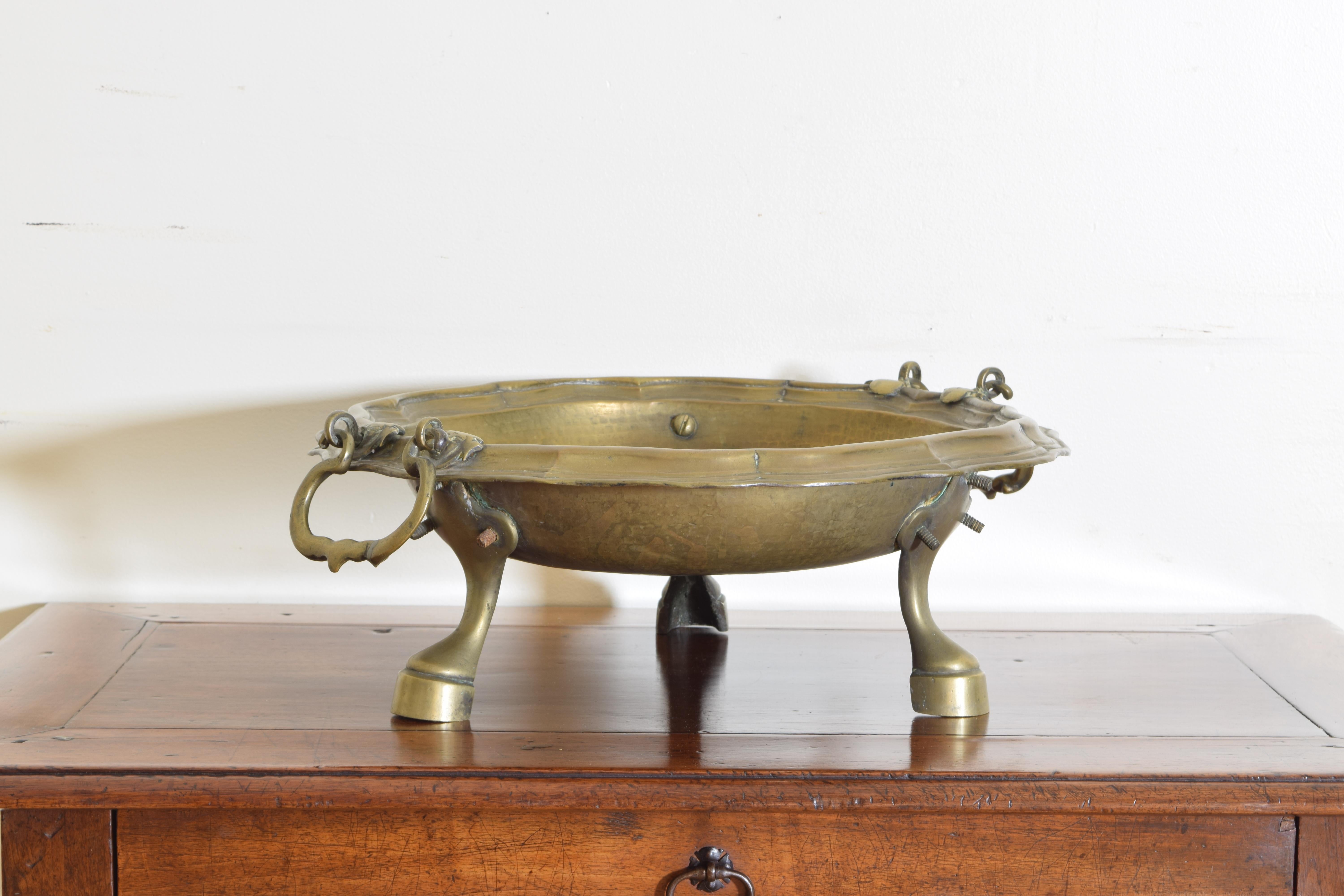 The shaped bowl with heavy cast brass handles, raised on hoof shaped feet, the original purpose of the bracciere was to hold coal or other combustible fuels in an effort to warm, often, the feet but at other times certainly an larger area, now used