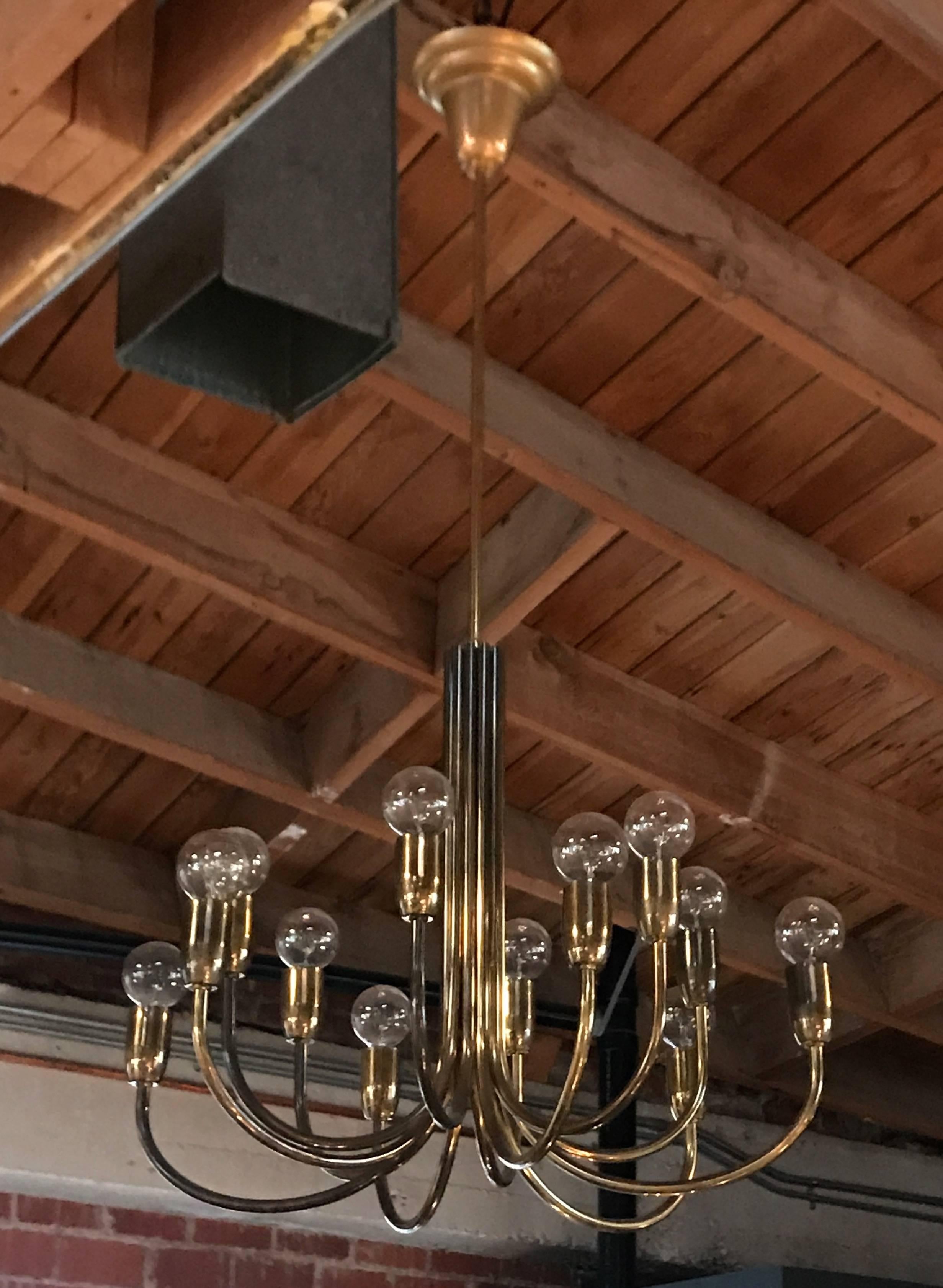 Mid-Century Modernist beautiful and elegant full brass chandelier with 12 branching arms on each arm one light.
 