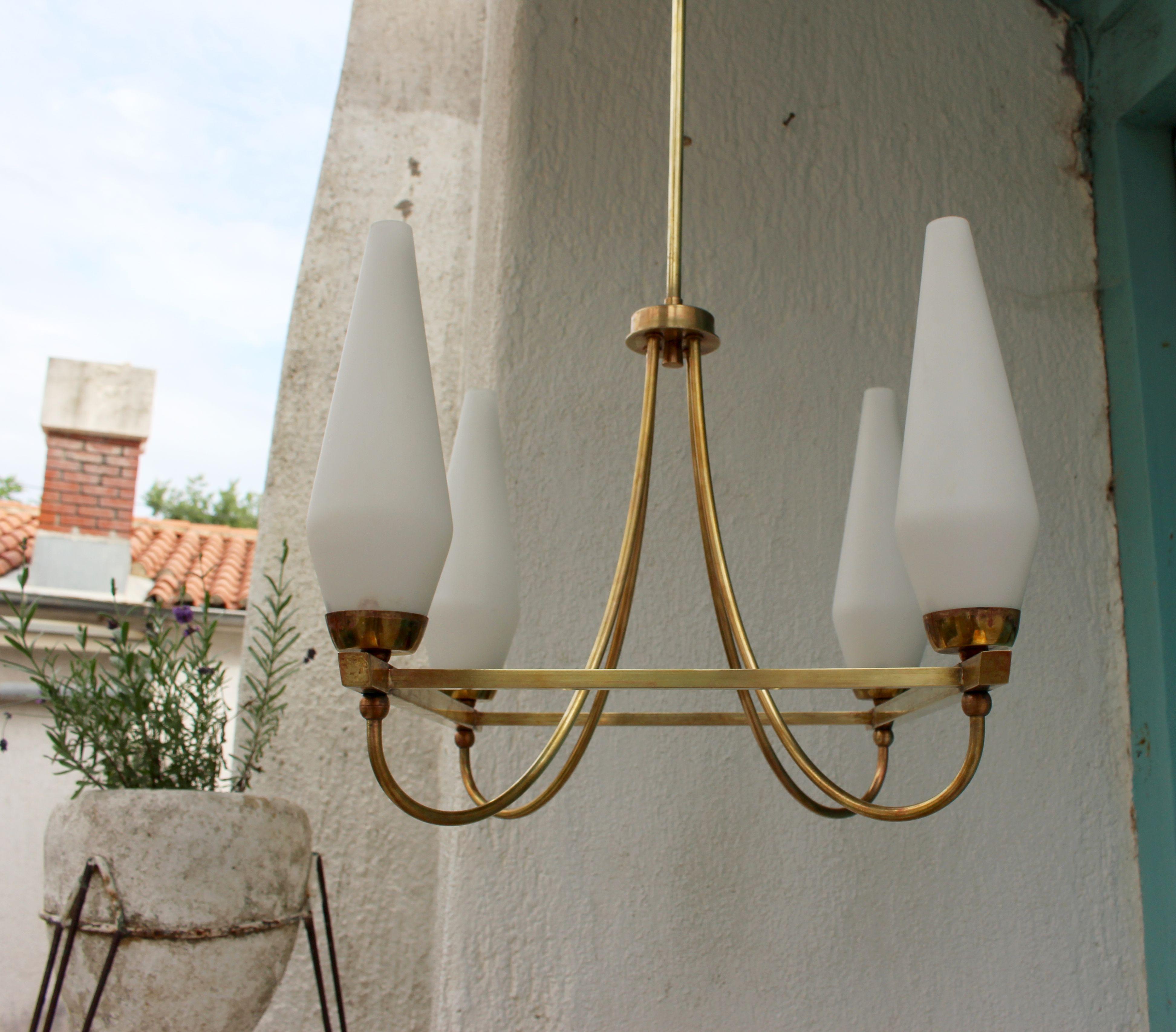 Mid century Italian brass chandelier with the opaline four shades.
  