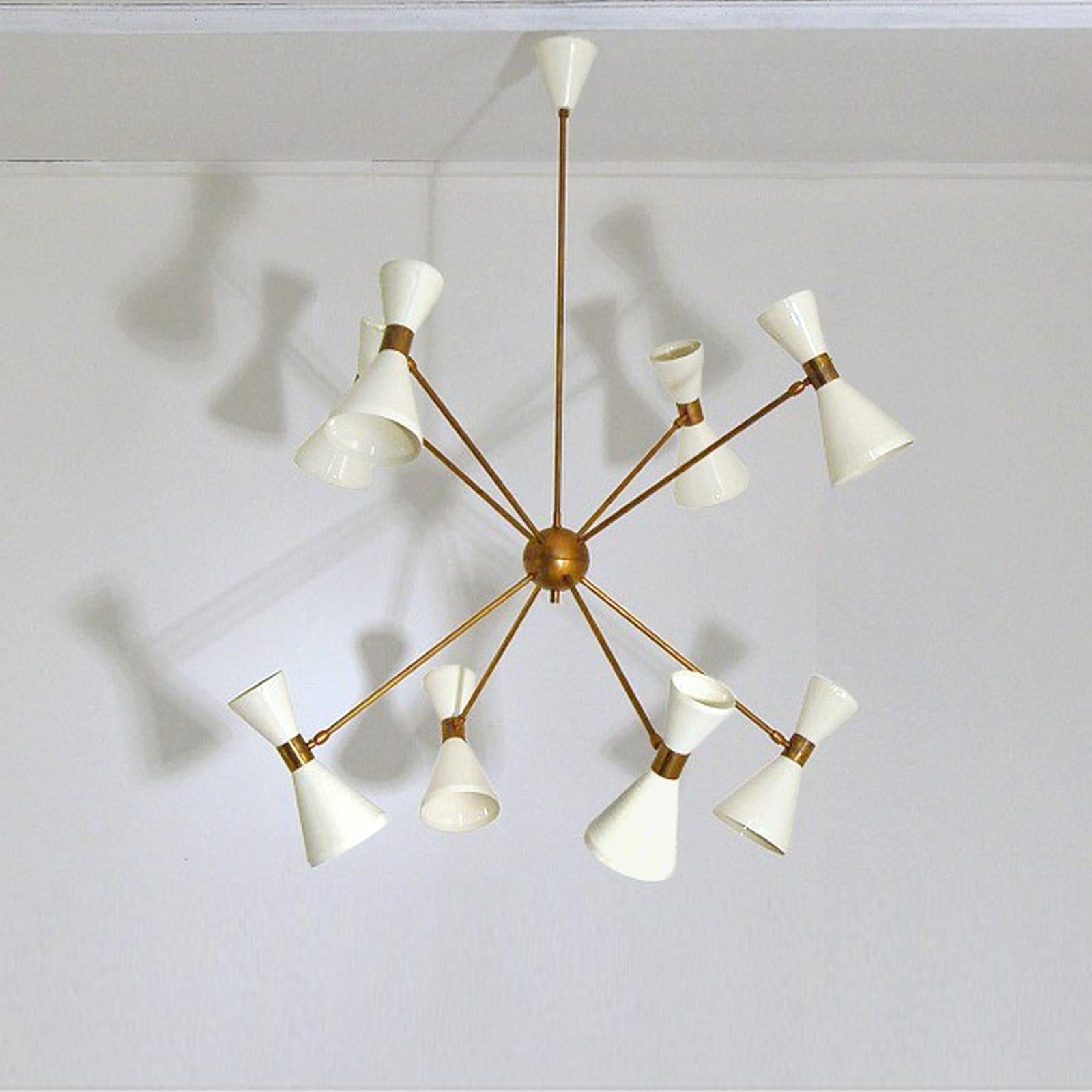 Italian Sputnik Chandelier with Eight Arms and Adjustable Diabolo Shades.
This elegant lighting in brass inspired by mid-century Italian design. It has 8 arms plugged to a brass sphere, each ending with a Diabolo shade, lacquered in light ivory. The