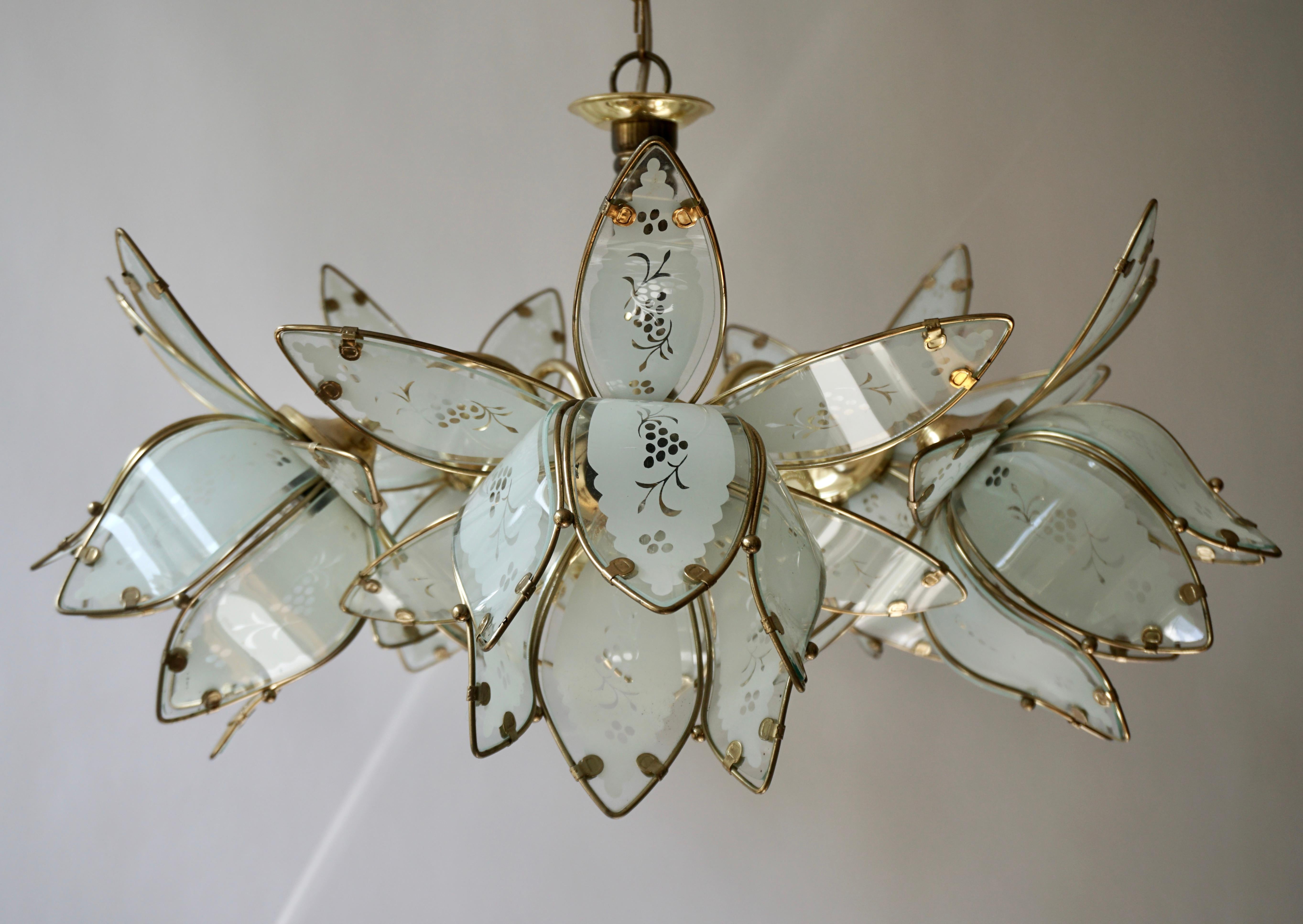 Five Italian chandeliers in brass with five white Murano glass flowers.

Measures: Diameter 26.7 inch - 68 cm.
Height fixture 15.7 inch - 40 cm.
Total height including the chain and canopy is 35.4 inch - 100 cm.
Please note that price is per item