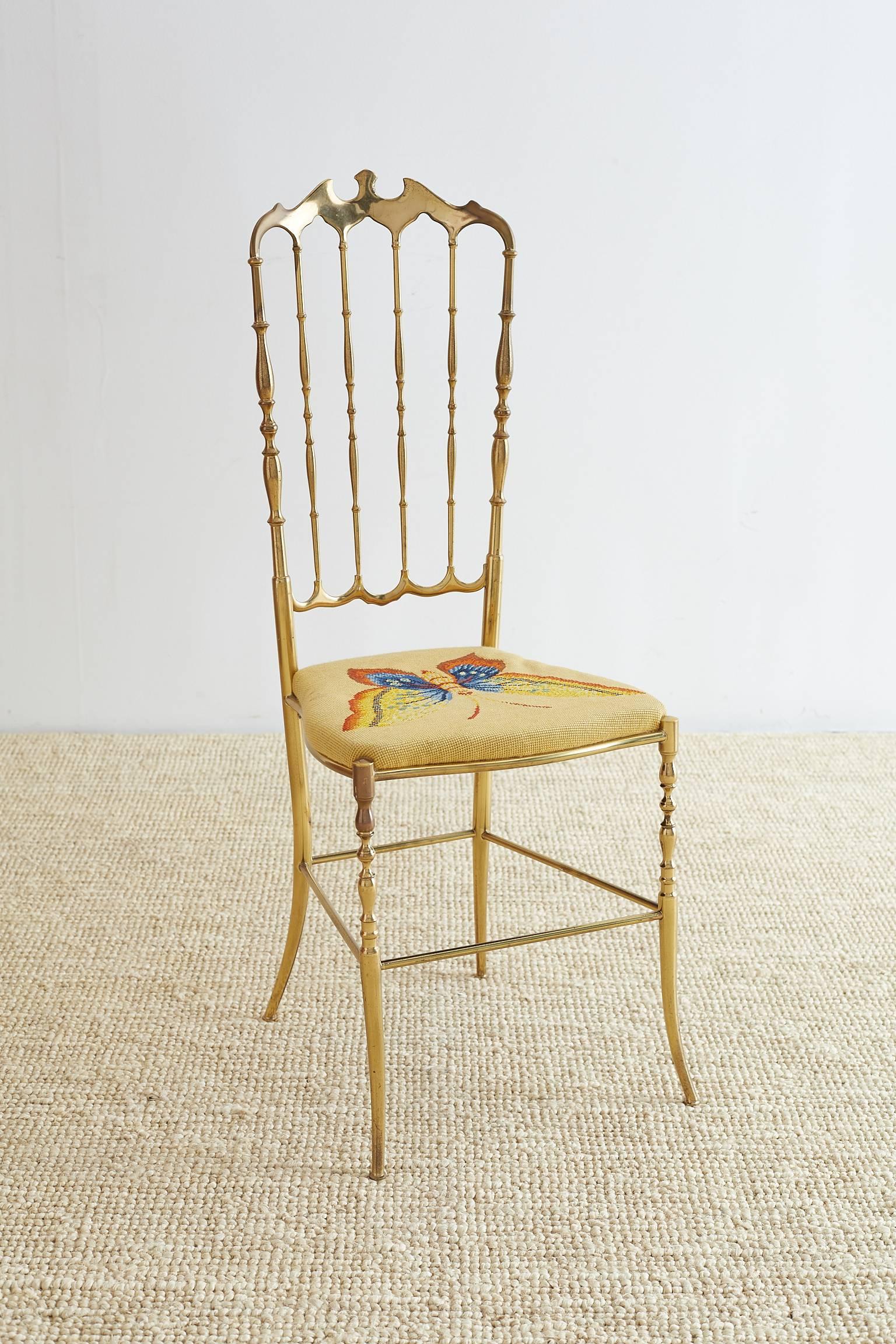 Mid-Century Modern Italian brass chiavari chair featuring a butterfly needlepoint upholstered seat. This chair was made with a high back 40 inch frame and a beautiful polished finish that now has a vintage brass patina.
