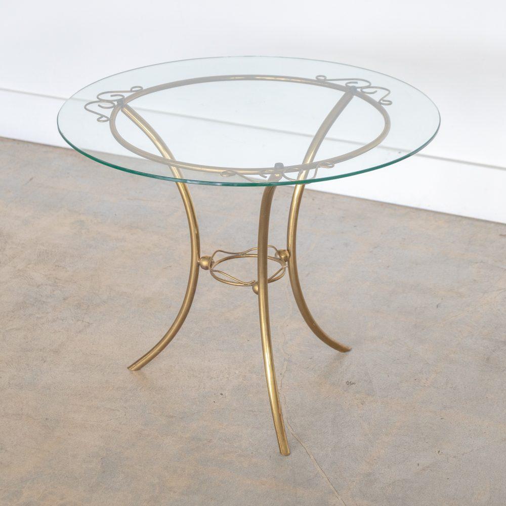 Beautiful Italian brass circular table with glass top from the 1950s. Original brass base with three curved legs and lovely wavy brass and ball details. Glass top has small chip on edge on underside, see photos. Perfect as a side table. Original