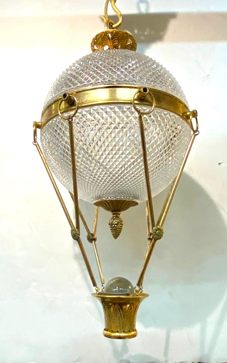 A wonderful and whimsical yet elegant Italian pendant light in the form of a hot air balloon. The balloon shade is comprised of two cut glass diamond pattern domes that sit securely in the brass framework of the balloon riggings. Suspended from the