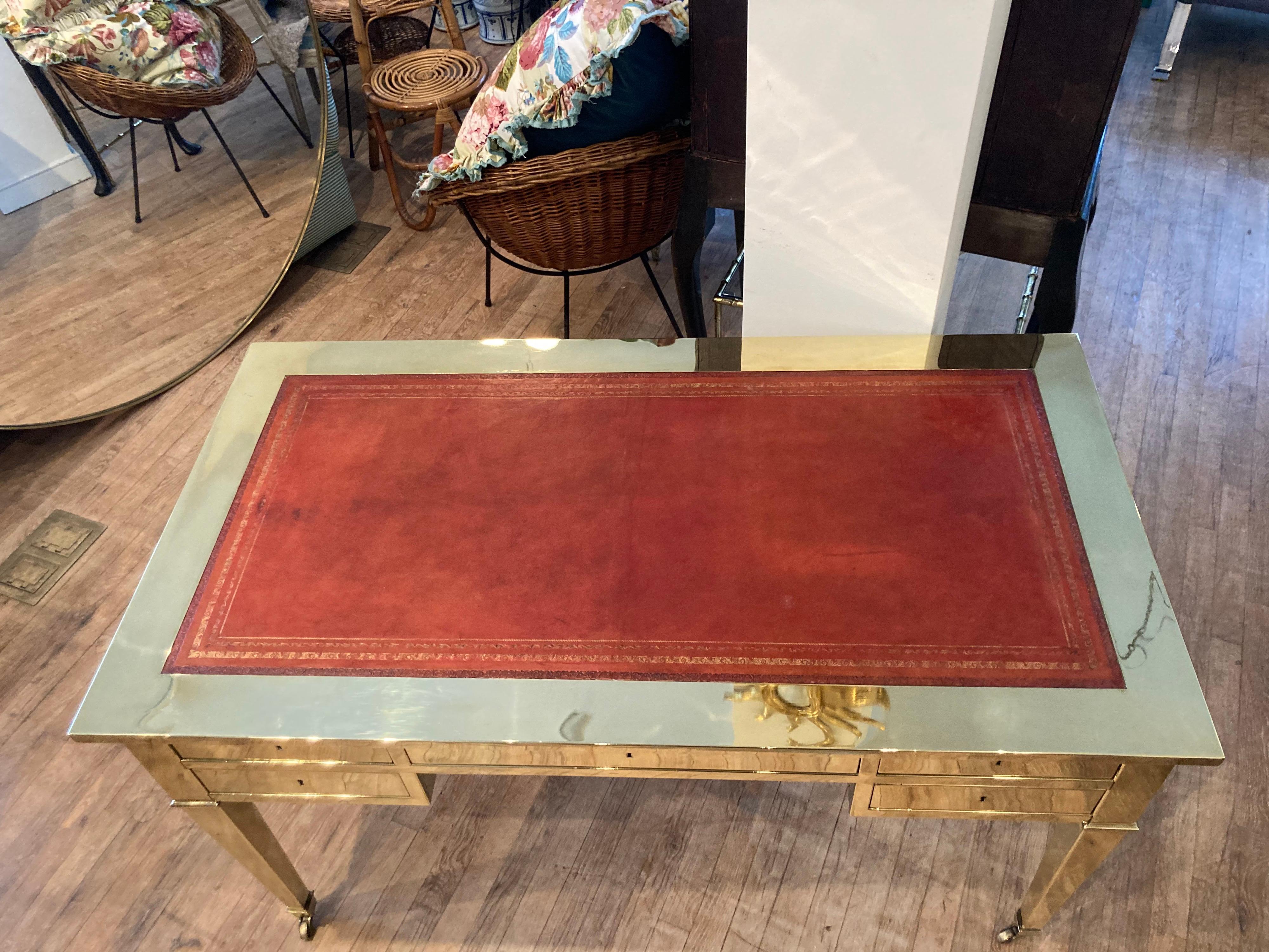Chic brass bureau plat style desk with red leather insert..... it has been stripped of it's lacquer and polished.... light wear to leather top as shown in photos..... made in Italy.