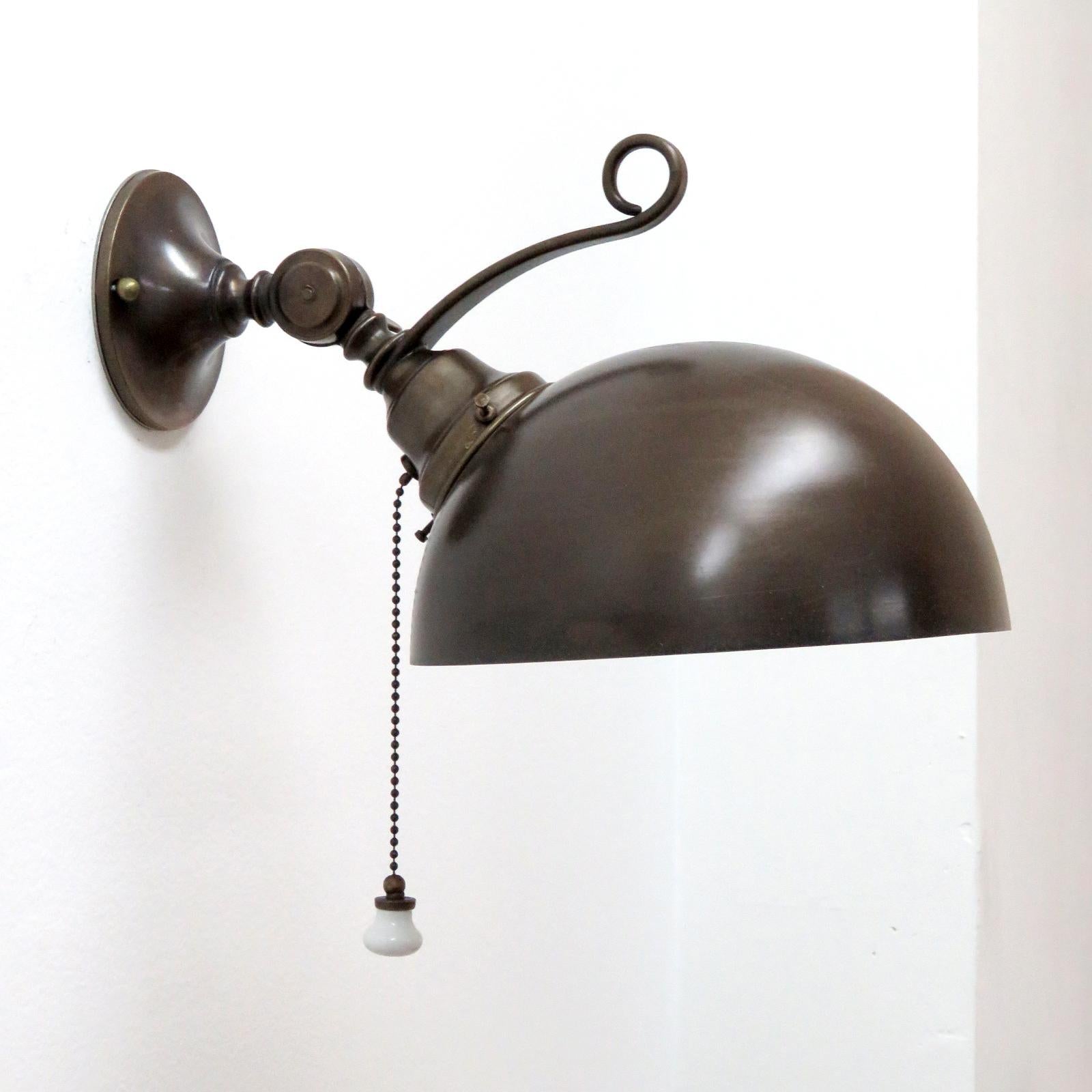 Wonderful Italian patinaed brass sconces, adjustable dome shade with cream colored interior and individual ceramic pull switch wired for US standards, one E27 socket each, max. wattage 75w per fixture, bulb provided as a one time courtesy. Priced