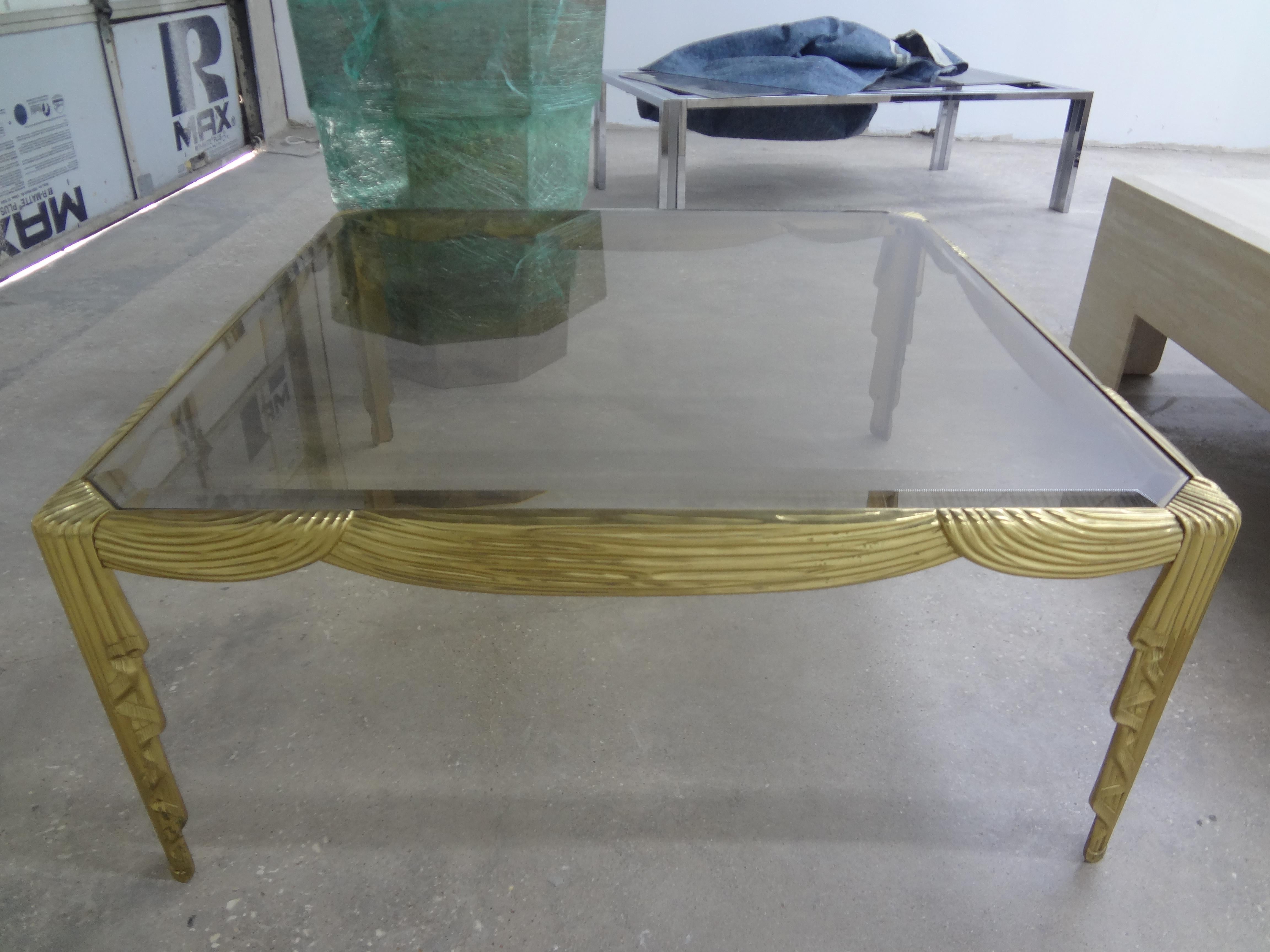 Italian brass coffee table with draped design. This lovely Italian modern / Hollywood Regency square brass coffee table or cocktail table has great draped swags on all sides and legs. It currently has a light colored beveled smoked glass top which