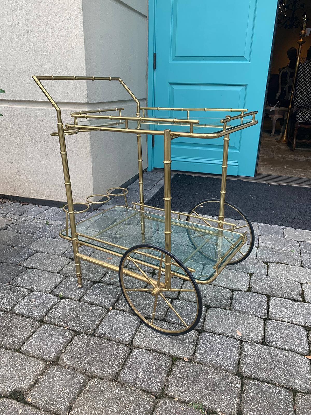 Italian brass faux bamboo bar cart with bottle carriers, circa 1970s
Two glass shelves
Glass is clear, turquoise showing is reflection of our front door.