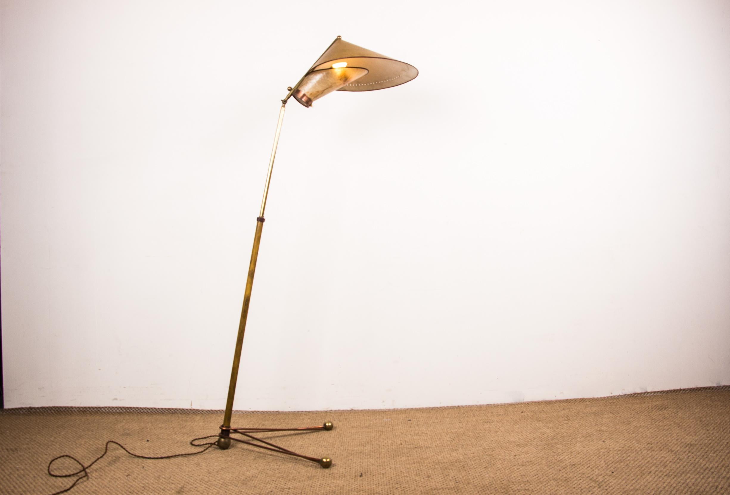 Exceptional Italian floor lamp. The light is encompassed by a cylindrical brass barrel above and a reflector, with an inlaid briar leaf, below.
V-shaped base with curved rods decorated with spheres at the ends.
The height of the floor lamp is also