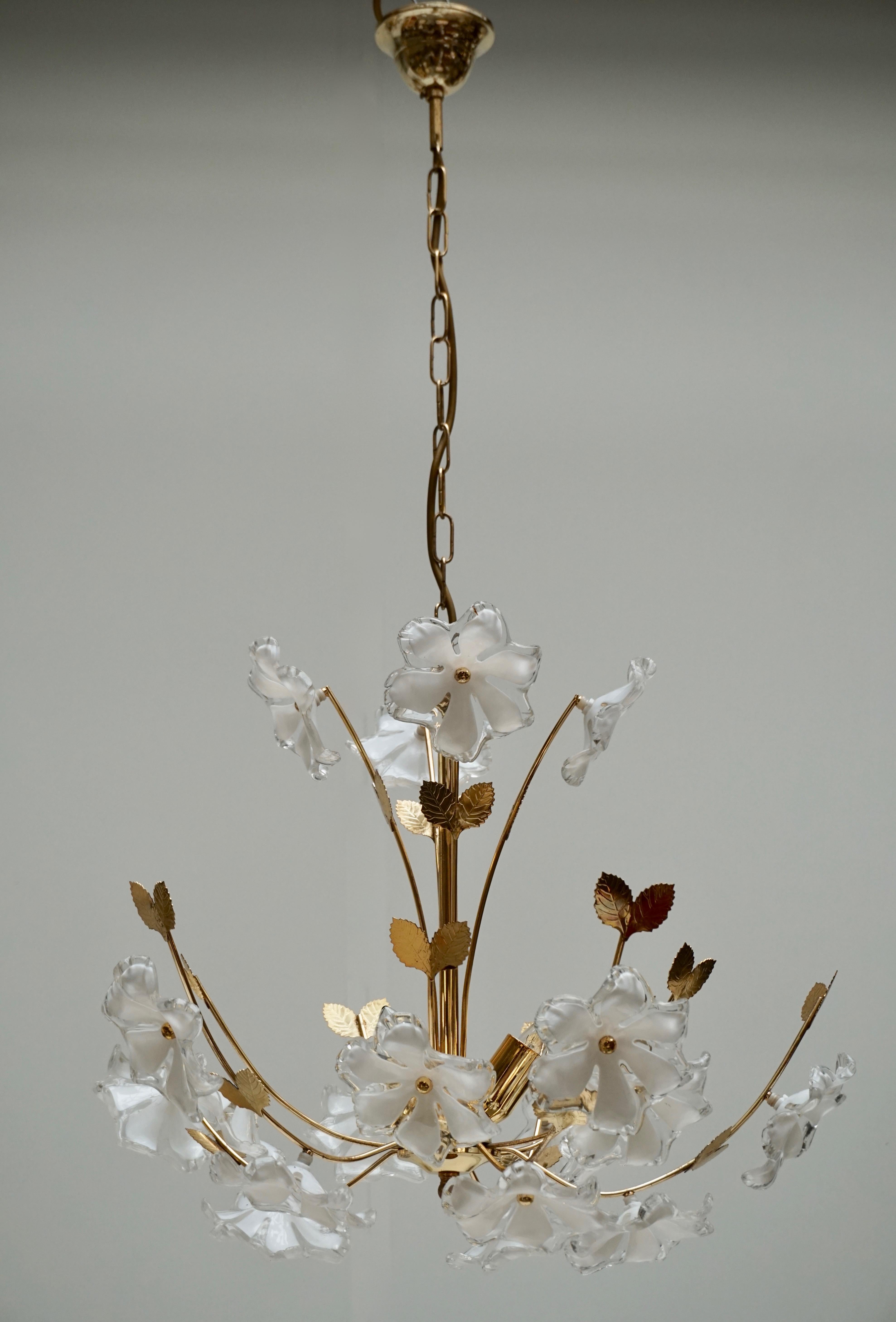 A beautiful brass and plastic flower chandelier made in Italy, 1960s. The chandelier requires three European E14 candelabra bulbs, each up to 40 watts. It is made of plastic flowers and a brass frame. 
Diameter 55 cm.
Height fixture 42 cm.
Total