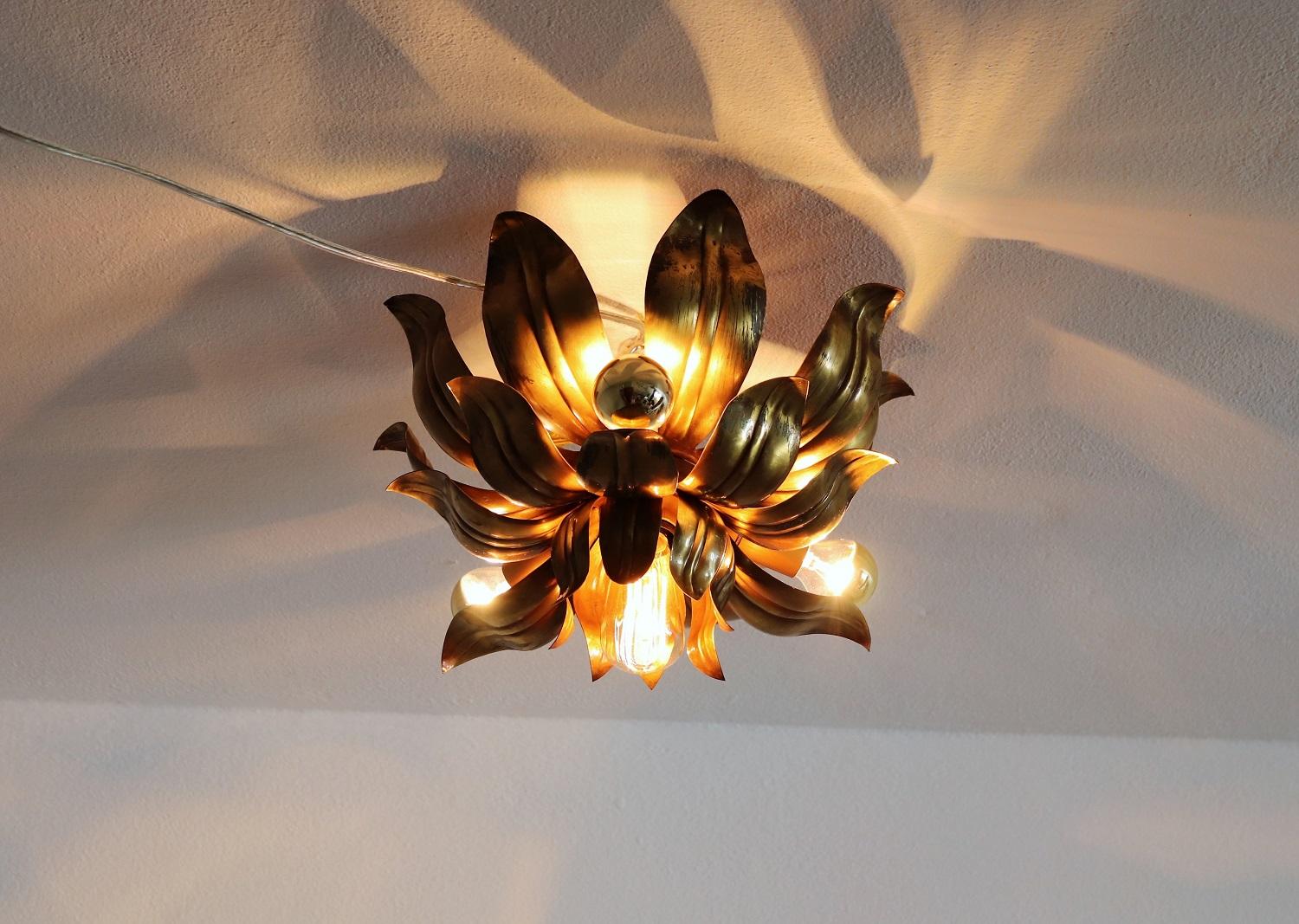 Beautiful and very decorative vintage flush mount or ceiling lamp in the shape of a big flower made of strong full brass sheets.
The burnished brass was intentionally stained and streaked. 
The lamp have one central bulb holder for one Edison bulb