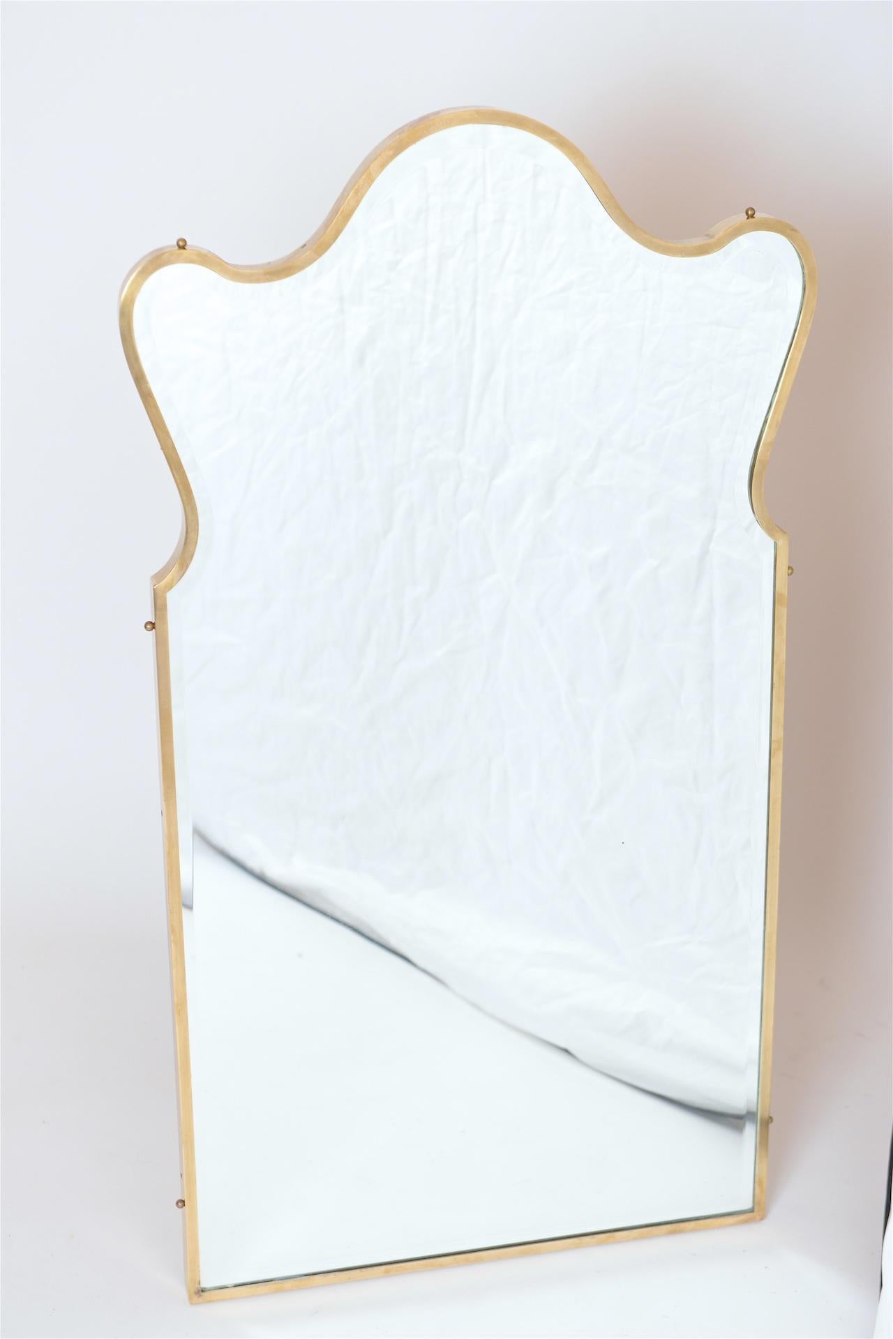 Brass frame mirror with curves.