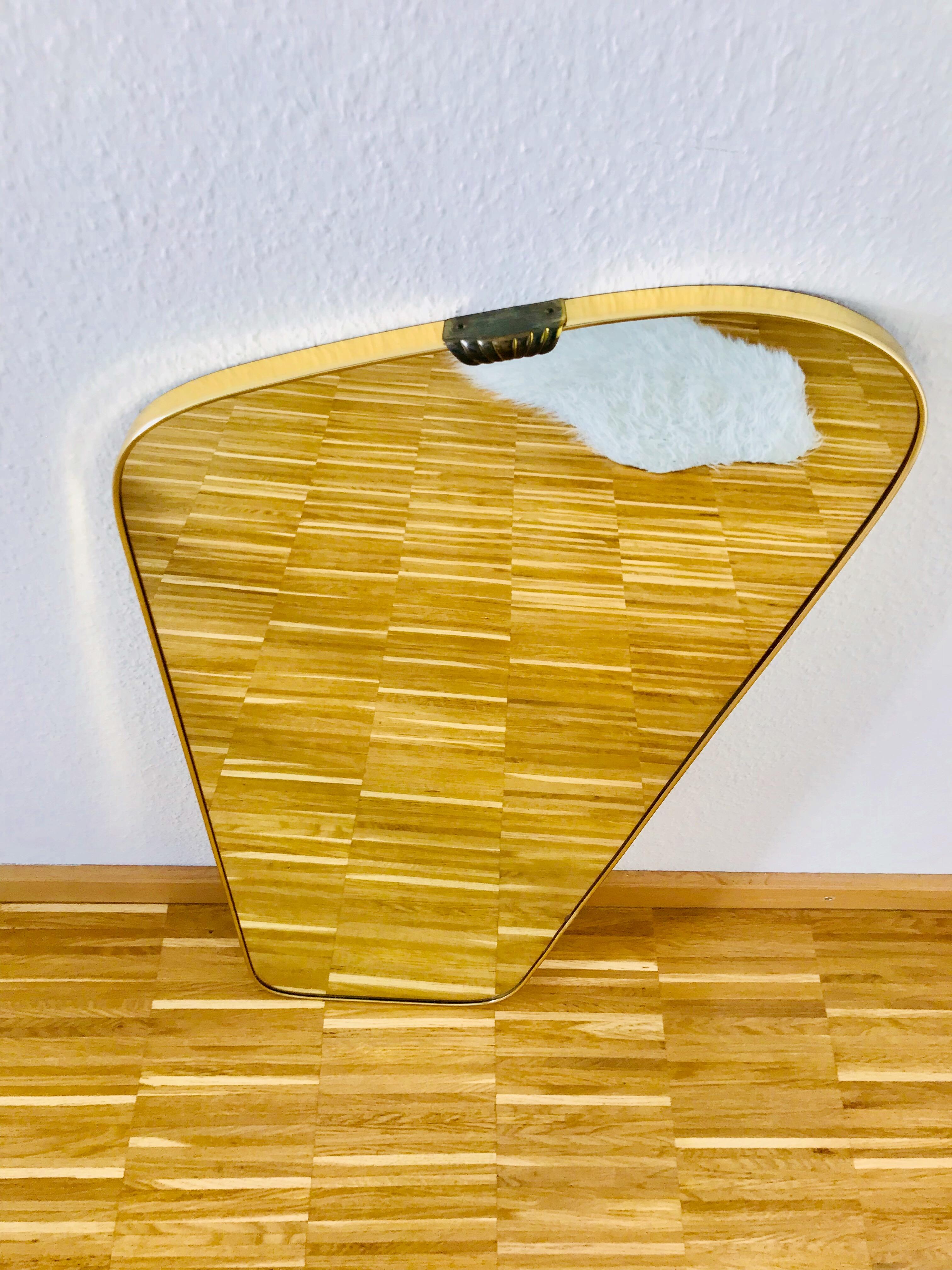 An asymmetrical Italian brass framed wall mirror. Beautiful with its amazing design.

  
