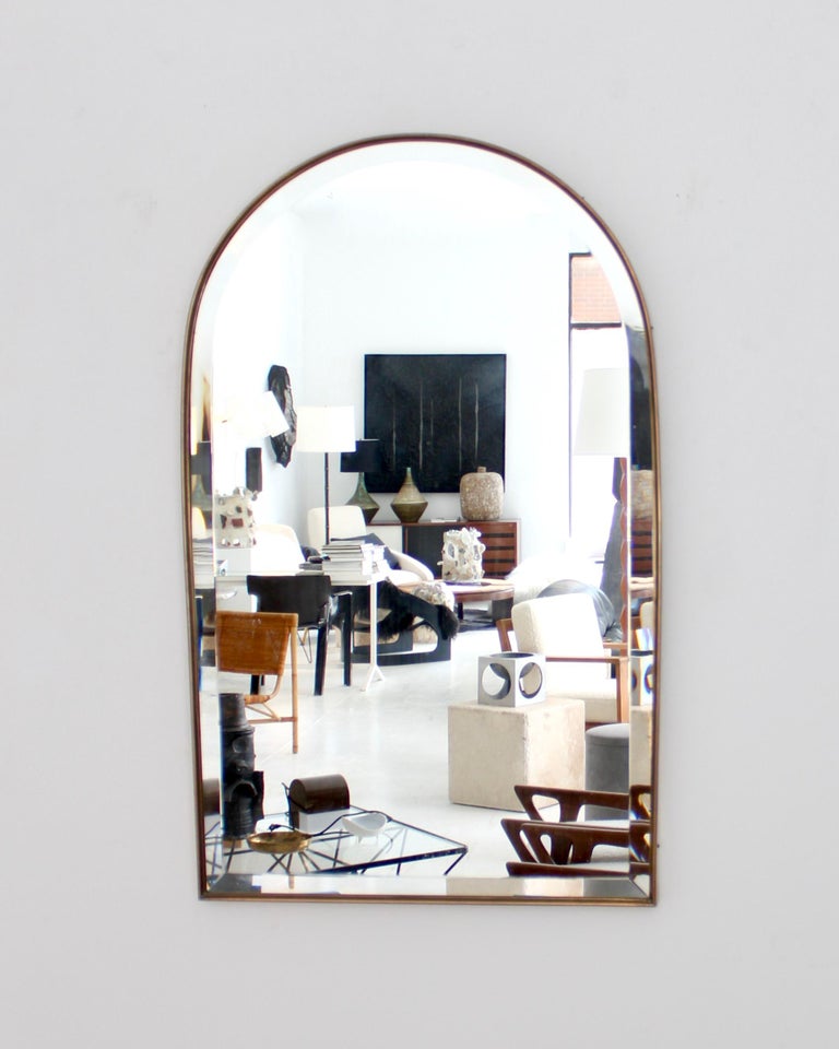 A classic Roman arch top vintage brass framed Italian mirror. 
Mirror has 1