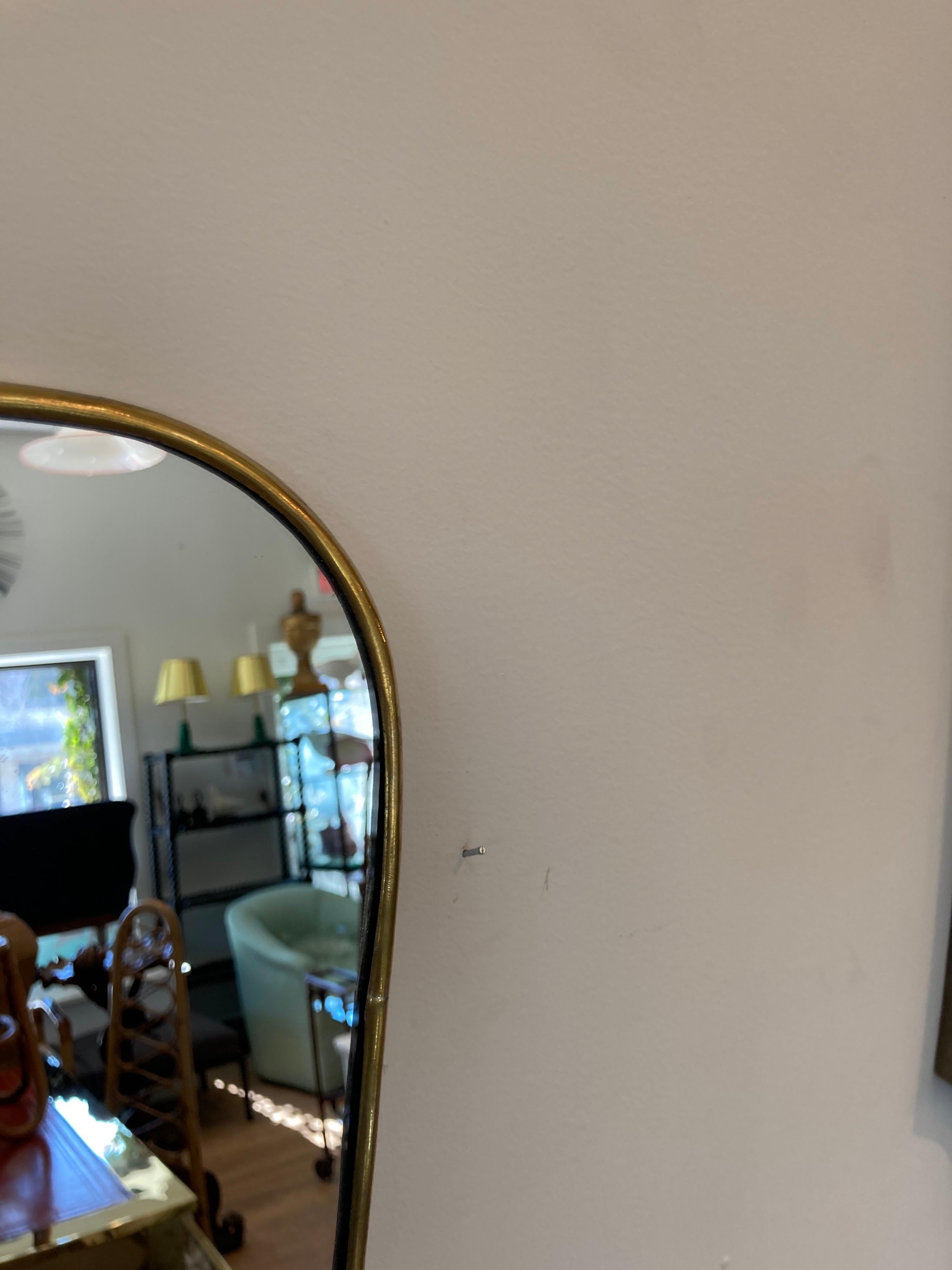 Large Italian brass framed mirror. Measures: 33.5