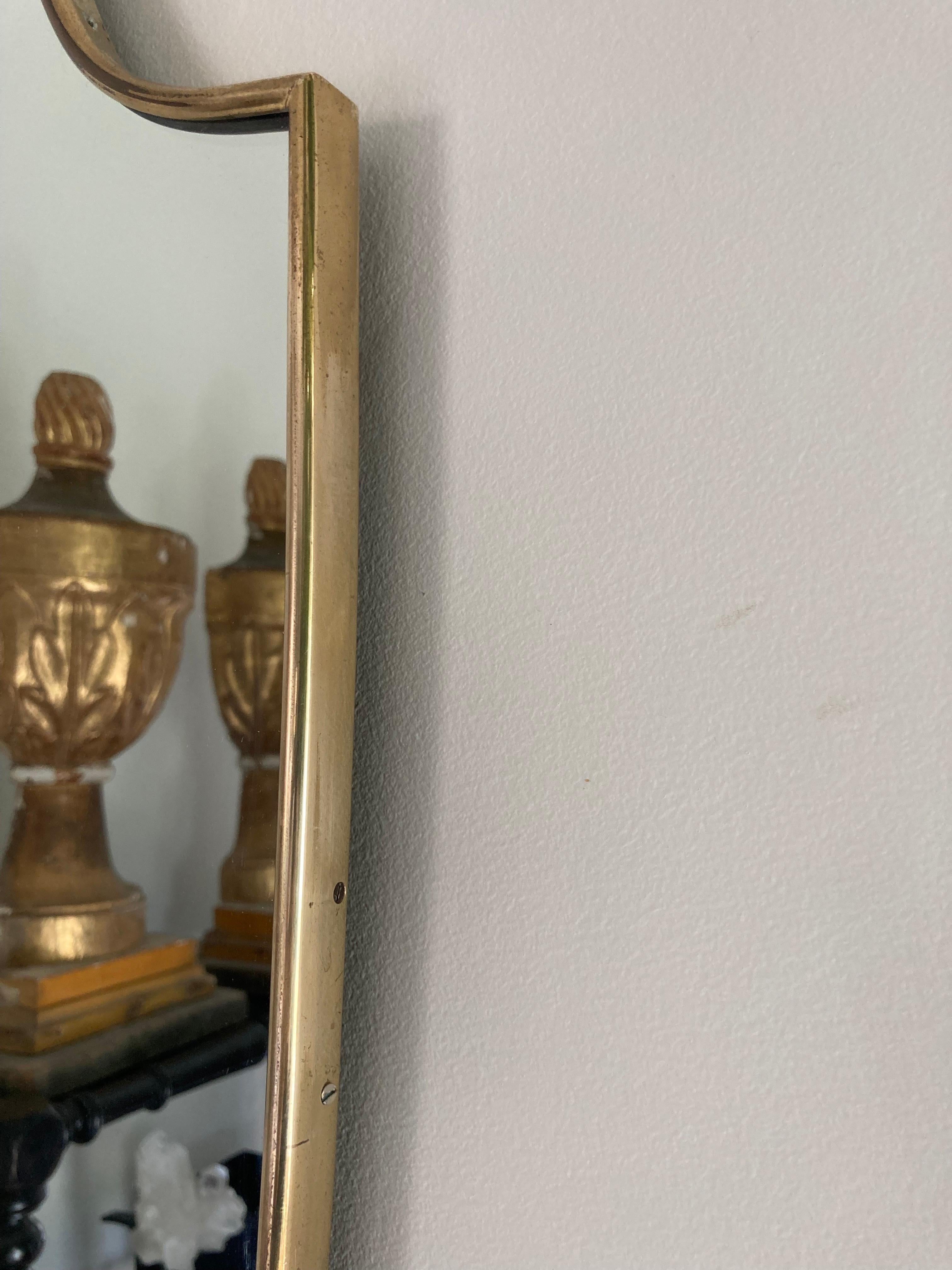 Italian shield shaped brass framed mirror from the 1960's.