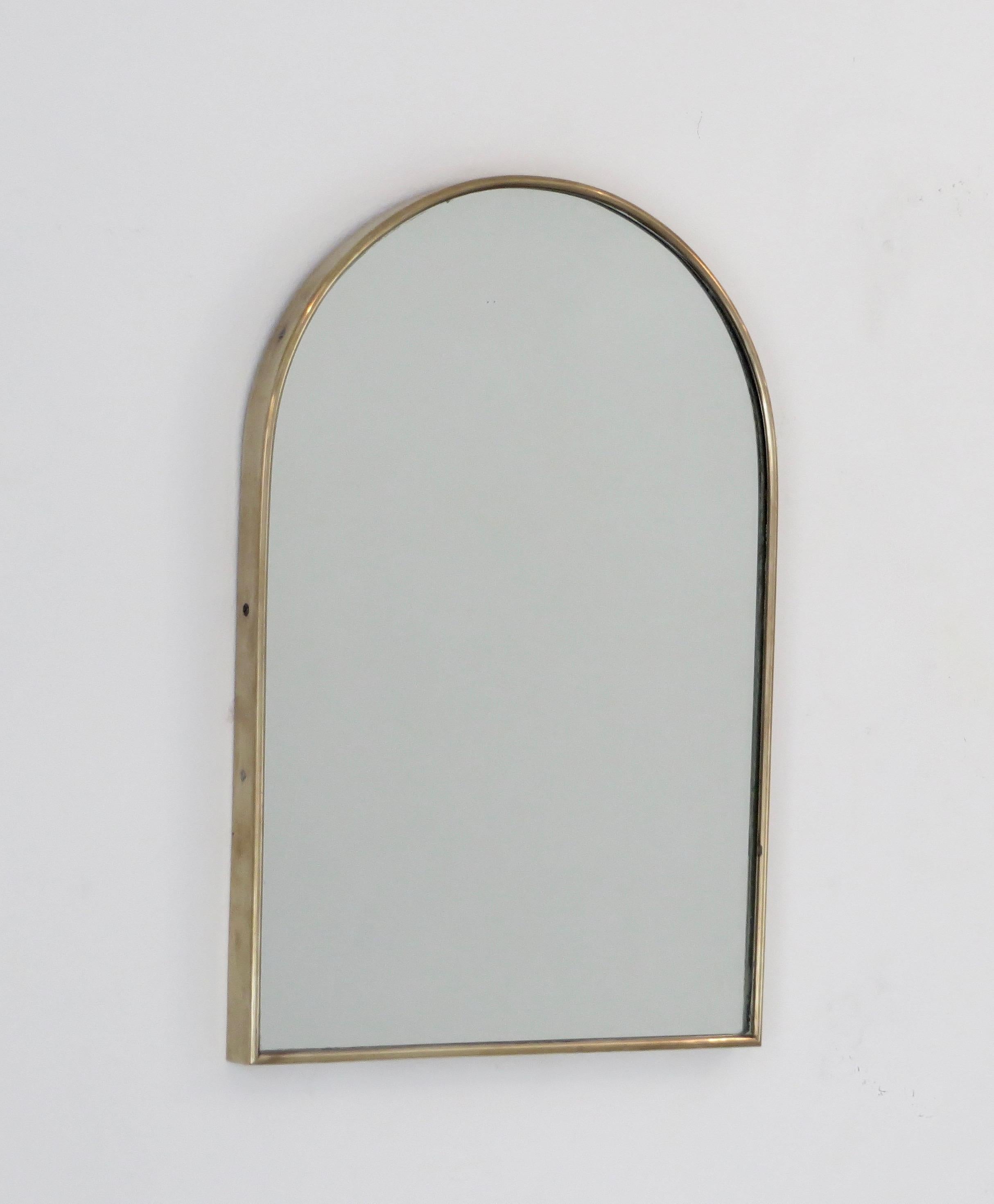 Italian vintage rounded top petit Italian brass framed wall mirror.
Wood backing with hook for hanging.
Patina is original but can be highly polished upon request.