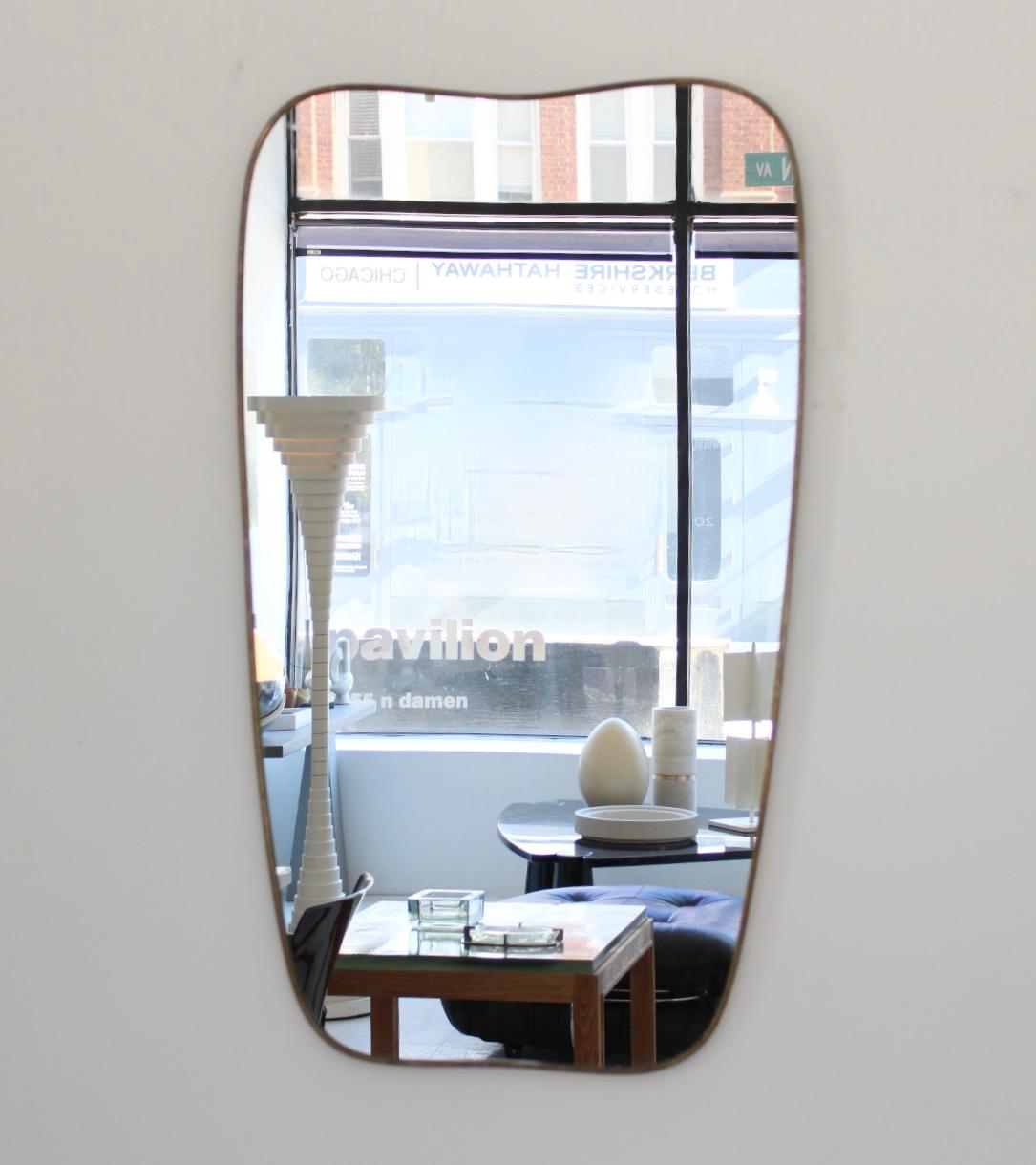 Elegant vintage wall mirror with deep solid brass frame and mirror glass. Made in Italy in the 1960s, original and not a reproduction.
The brass frame has a very nice patina and may be polished if desired.
At the back the mirror is reinforced with a