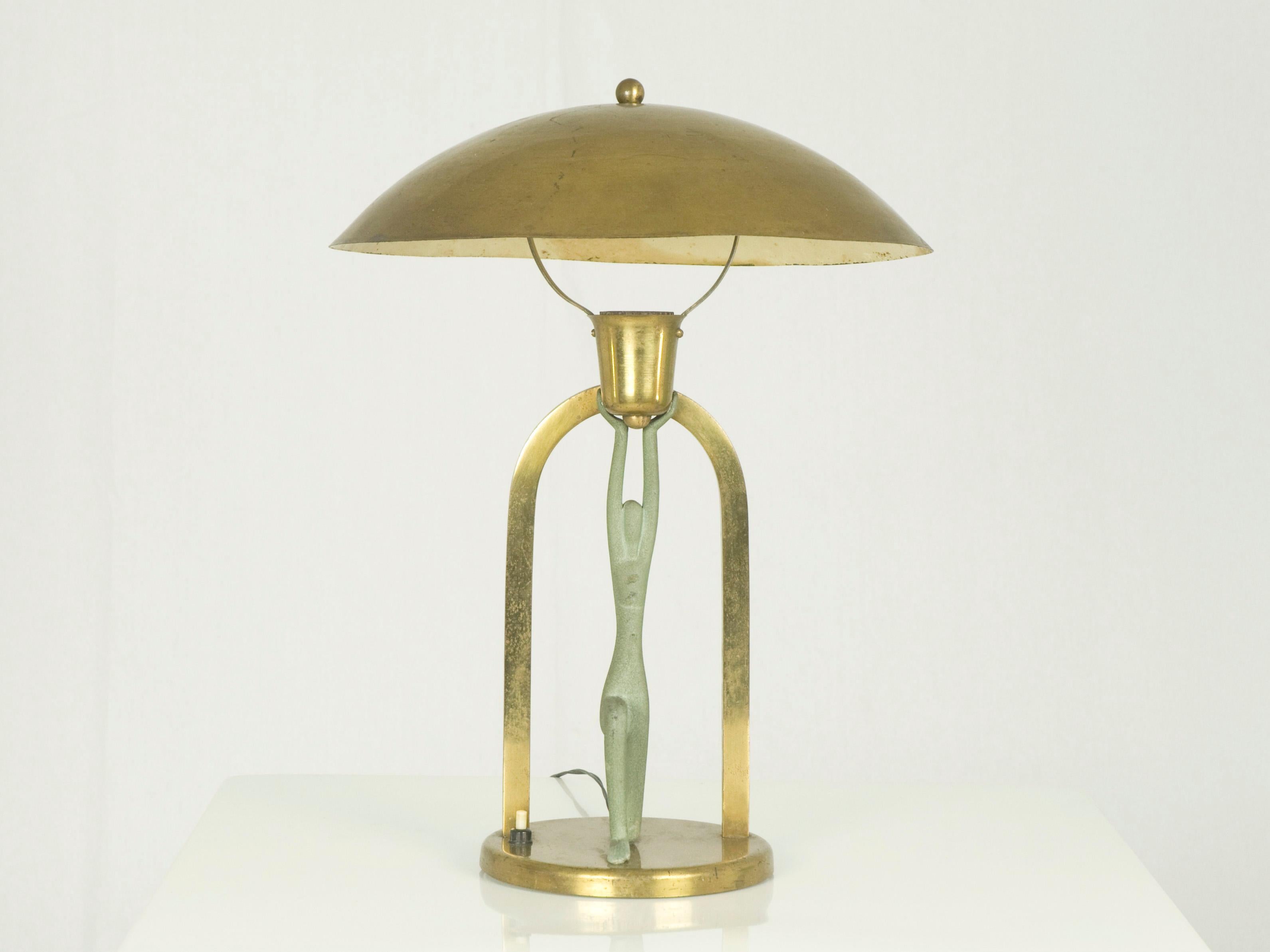 This unusual table lamp was produced in Italy around 1930-40s. It is made from painted and polished brass with a female figure which supports the lamp shade.
It remains in a good vintage condition: wear consistent with age and use; some paint