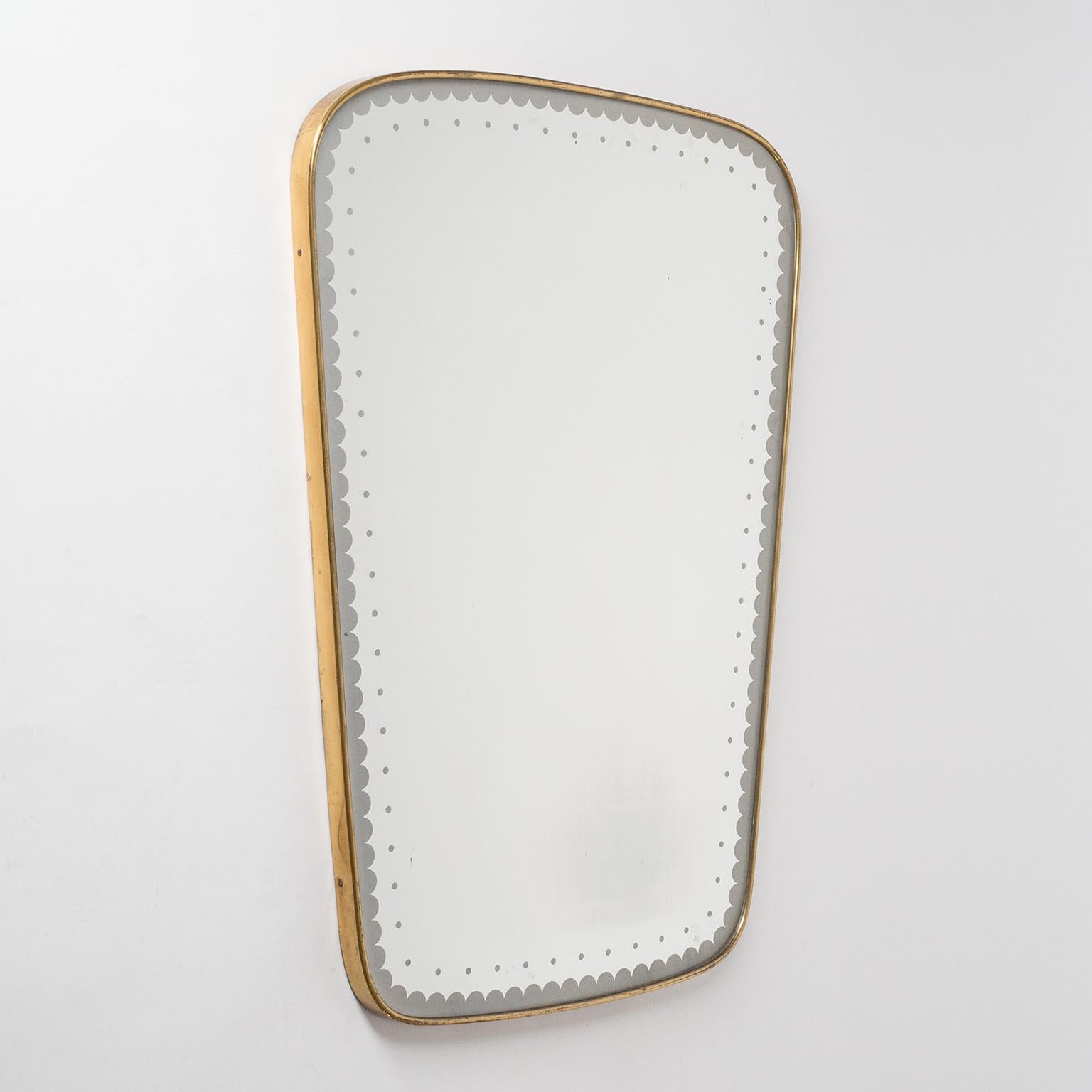 Rare Italian midcentury brass mirror from the 1940-1950s. The mirror has a lovely patterned border which was etched or printed onto the glass before the reflective coating was applied. Very nice original condition with patina on the continuous brass