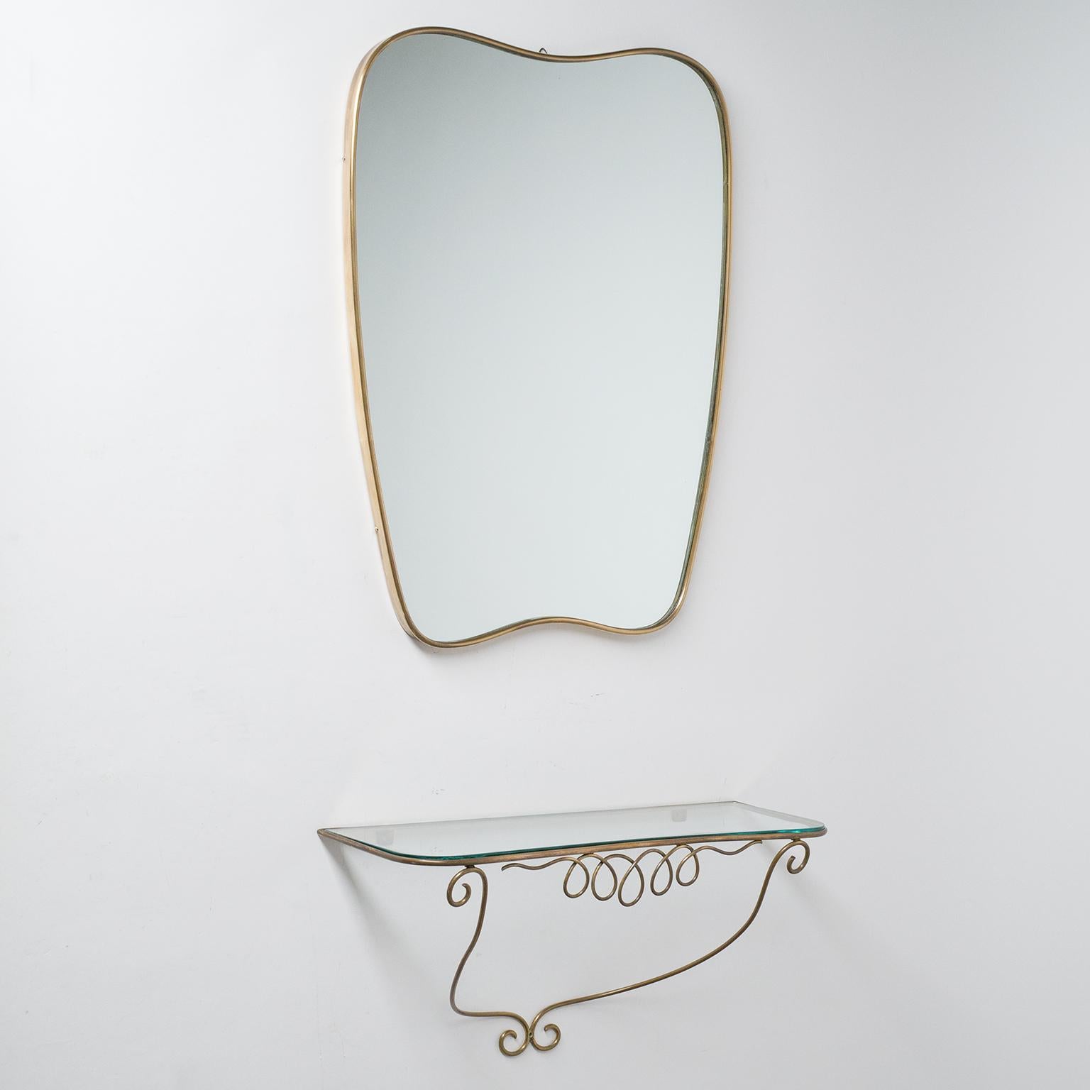 Italian brass mirror and console in the style of Gio Ponti, circa 1950. 
Measures: Mirror height 23inches/59cm, width 18inches/45cm, depth 1inch/2.5cm; Console height 11inches/27cm, width 20inches/51cm, depth 7inches/18cm.