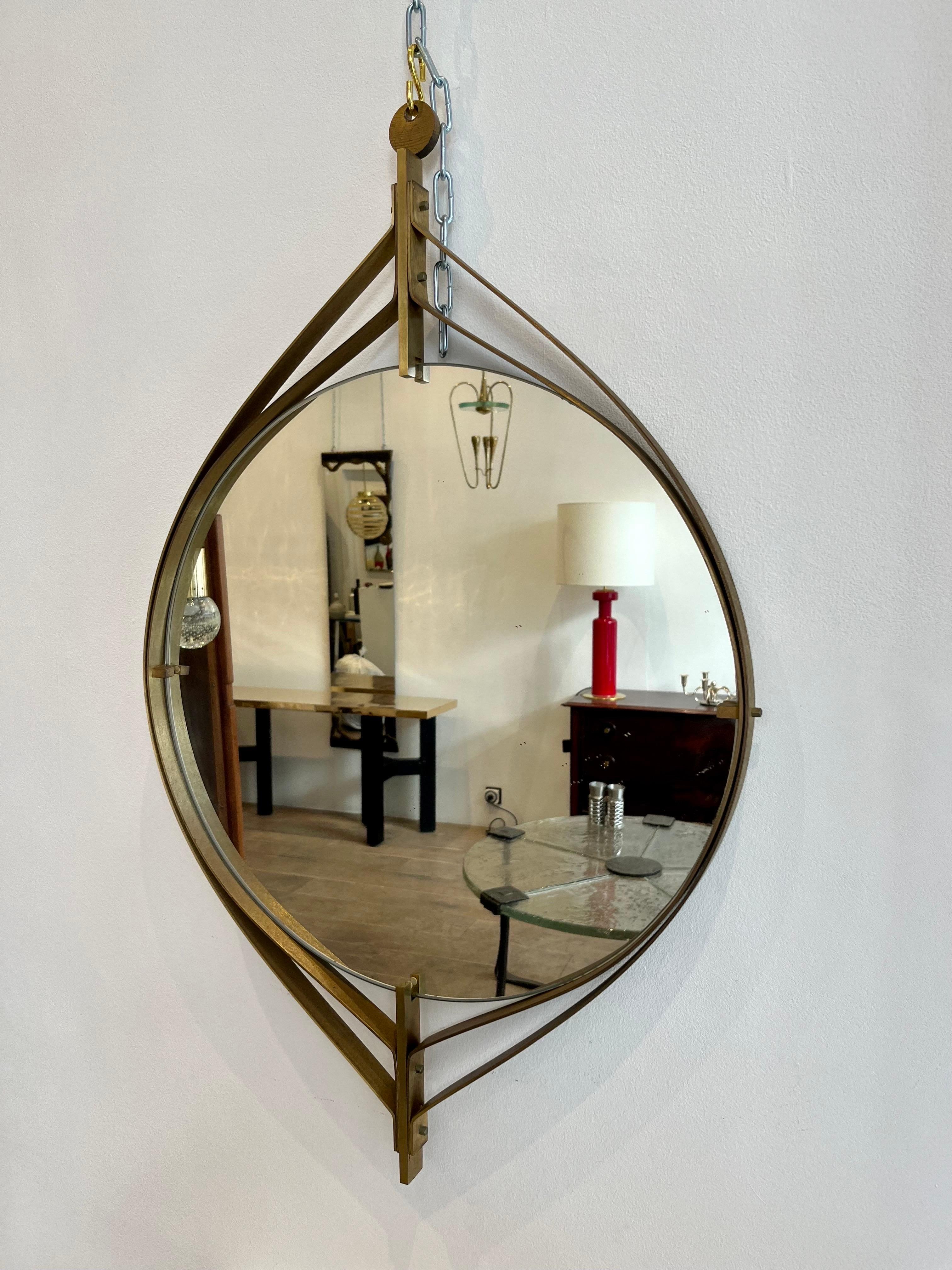Luciano Frigerio is an Italian designer well active in the 1960s-70s. He designed elegant furniture in a brutalist chic style. The quality of his creations is quite excellent. The present mirror is made of brass. The design is abstract reminding the