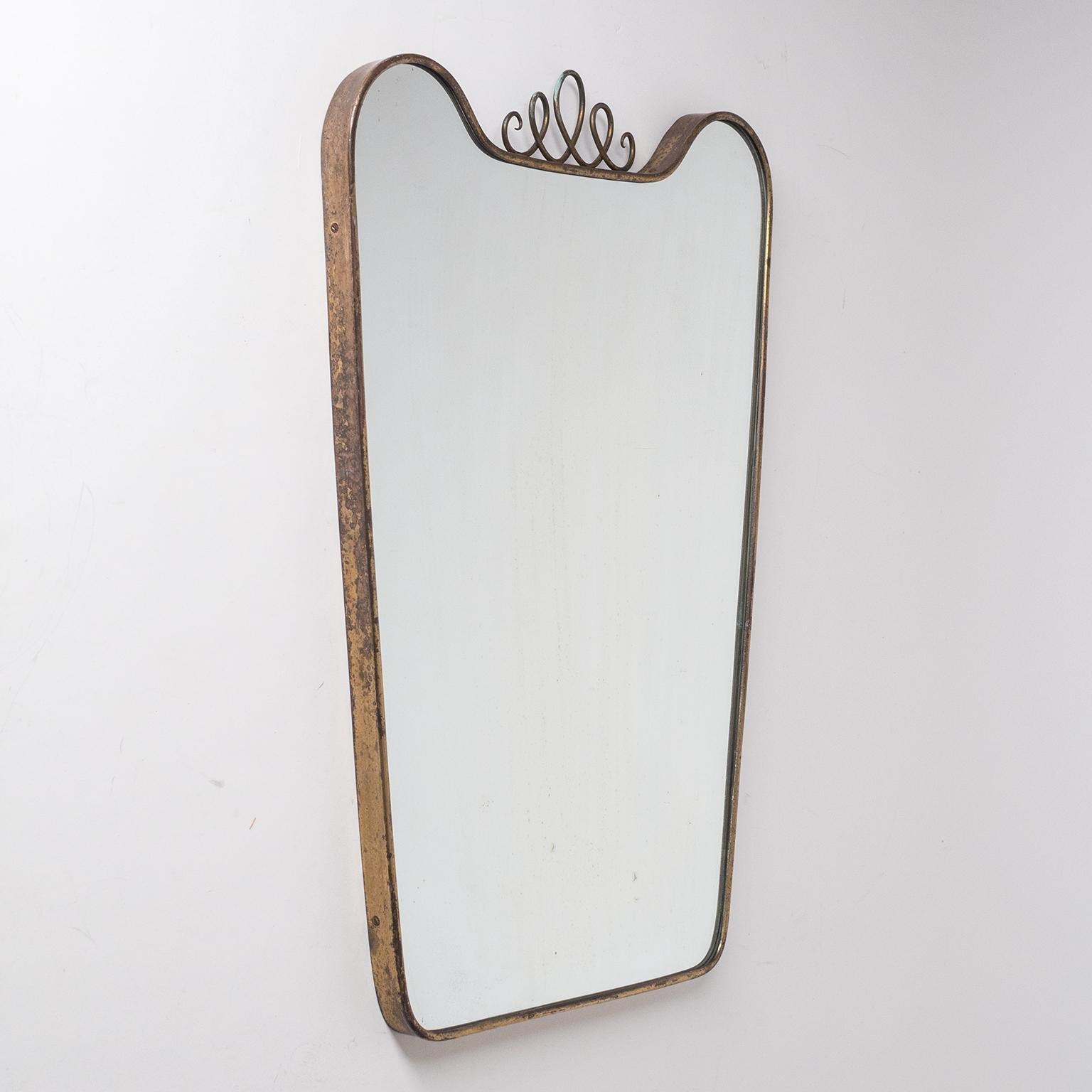 Italian brass mirror from the 1940-1950s. Heavy patina on the brass and mirror (steaks and specks).