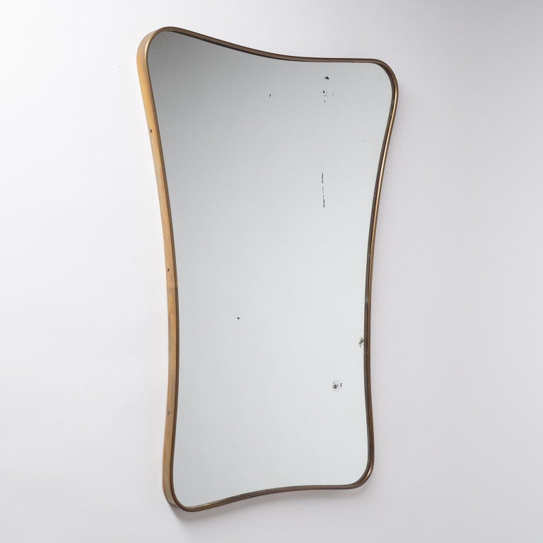 Italian brass mirror from the 1950s. Continuous tapered brass frame with original mirror.