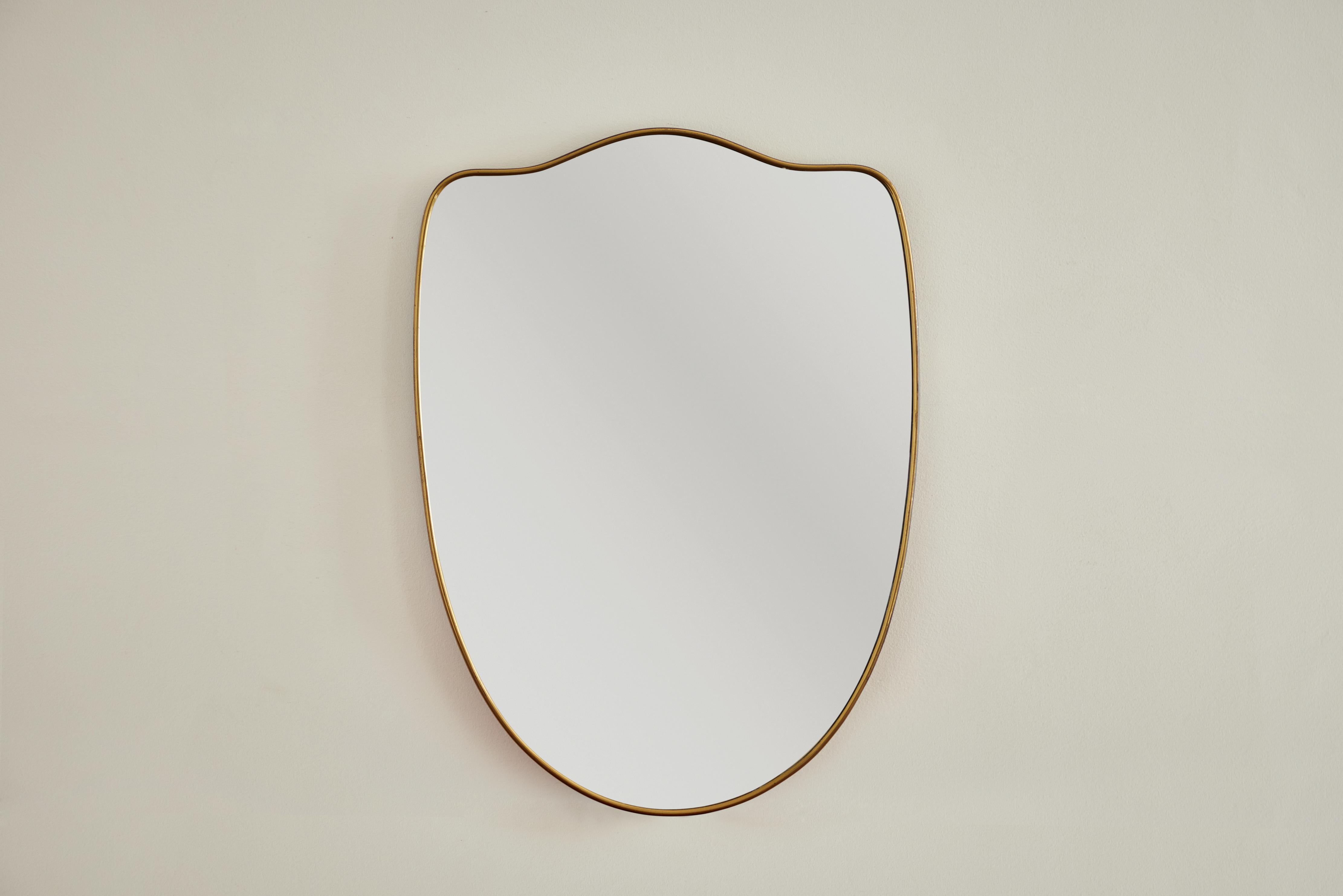 Italian patinated brass framed wall mirror. Made in Italy circa 1960s.