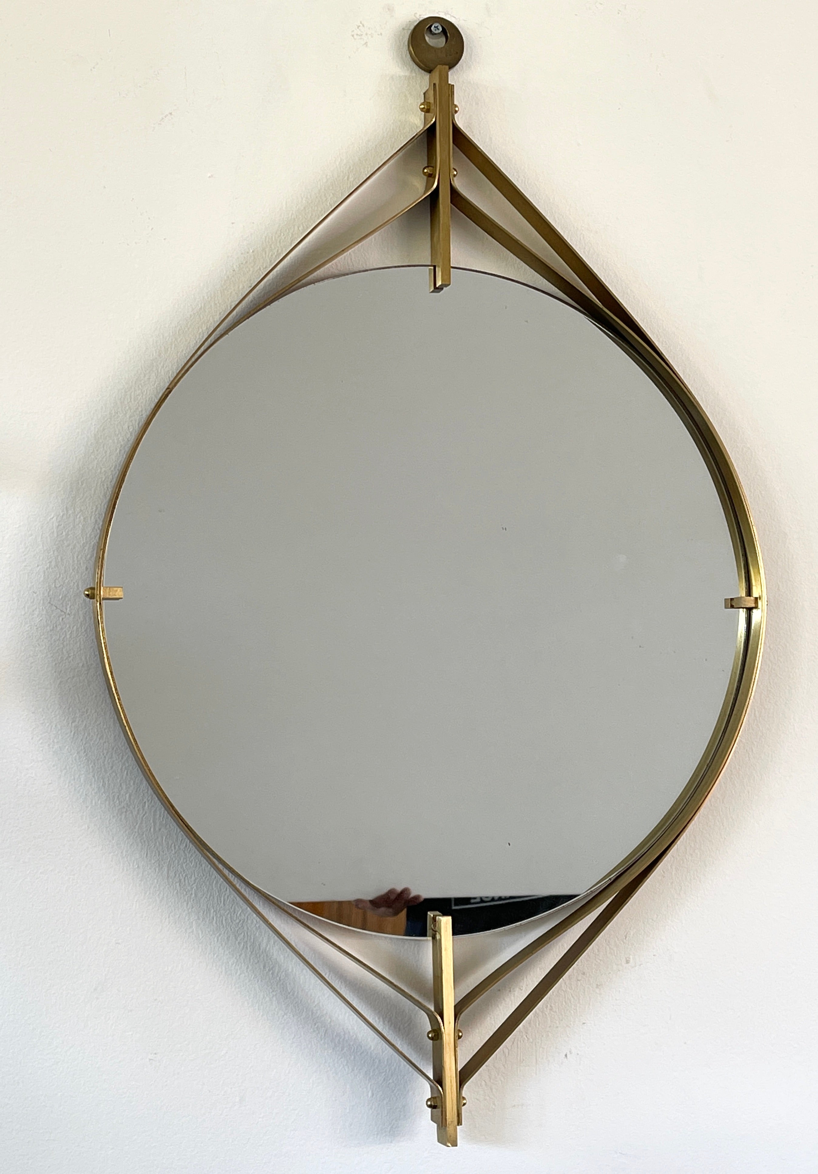 1950's Italian brass mirror floating in an intricate concentric design.