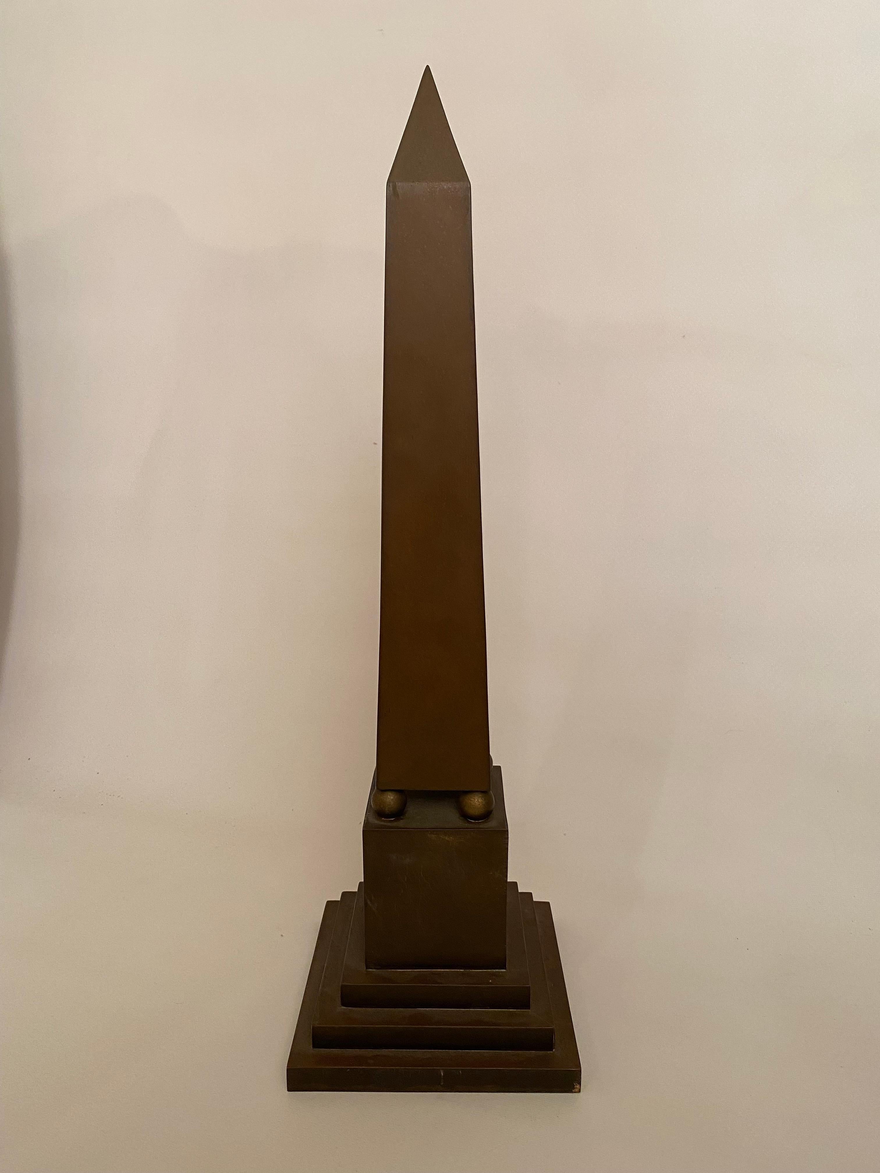 Large Italian brass obelisk. Stamped, Made In Italy on the underside. Circa 1960-70. Good condition with overall dark patina and tarnish. Wear and minor scratches commensurate with age and use. Structurally sound.

Approximately 20.25