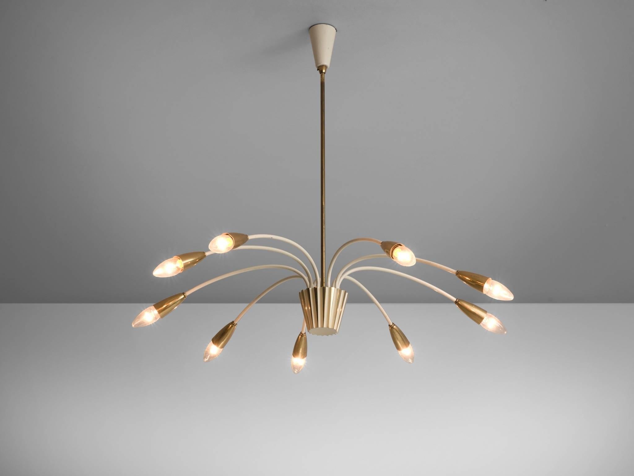 Pendant, brass, white coated metal, Italy, circa 1960.

This brass, large nine armed biomorphic pendant is both modern and Classic at the same time, a trait that Italian lights often achieve. The chandelier is delicate but also features a certain