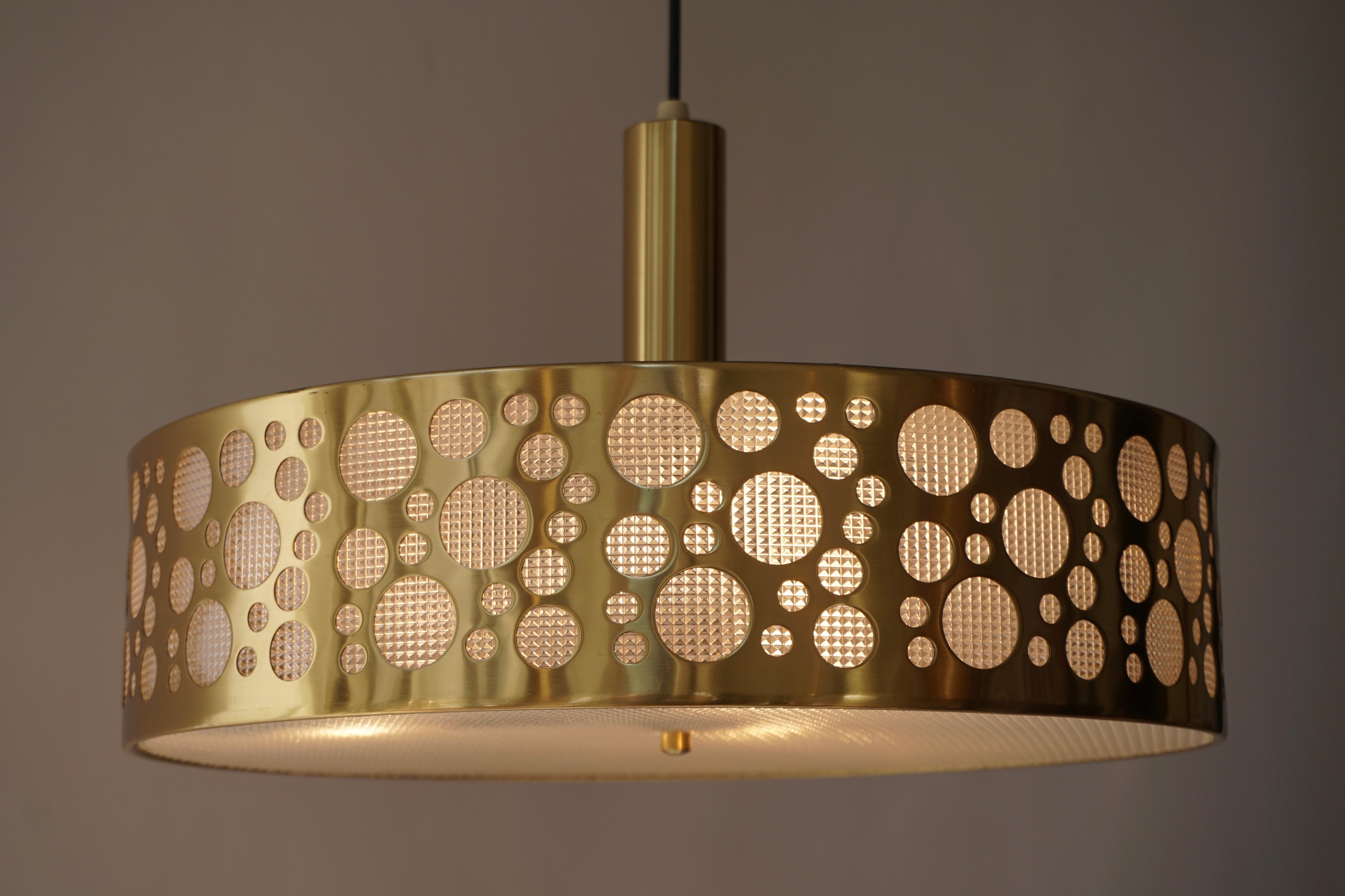 Mid-Century Modern brass 3-light chandelier, ceiling light, circa 1970. Shaped as an UFO or flying saucer, a popular topic during the 