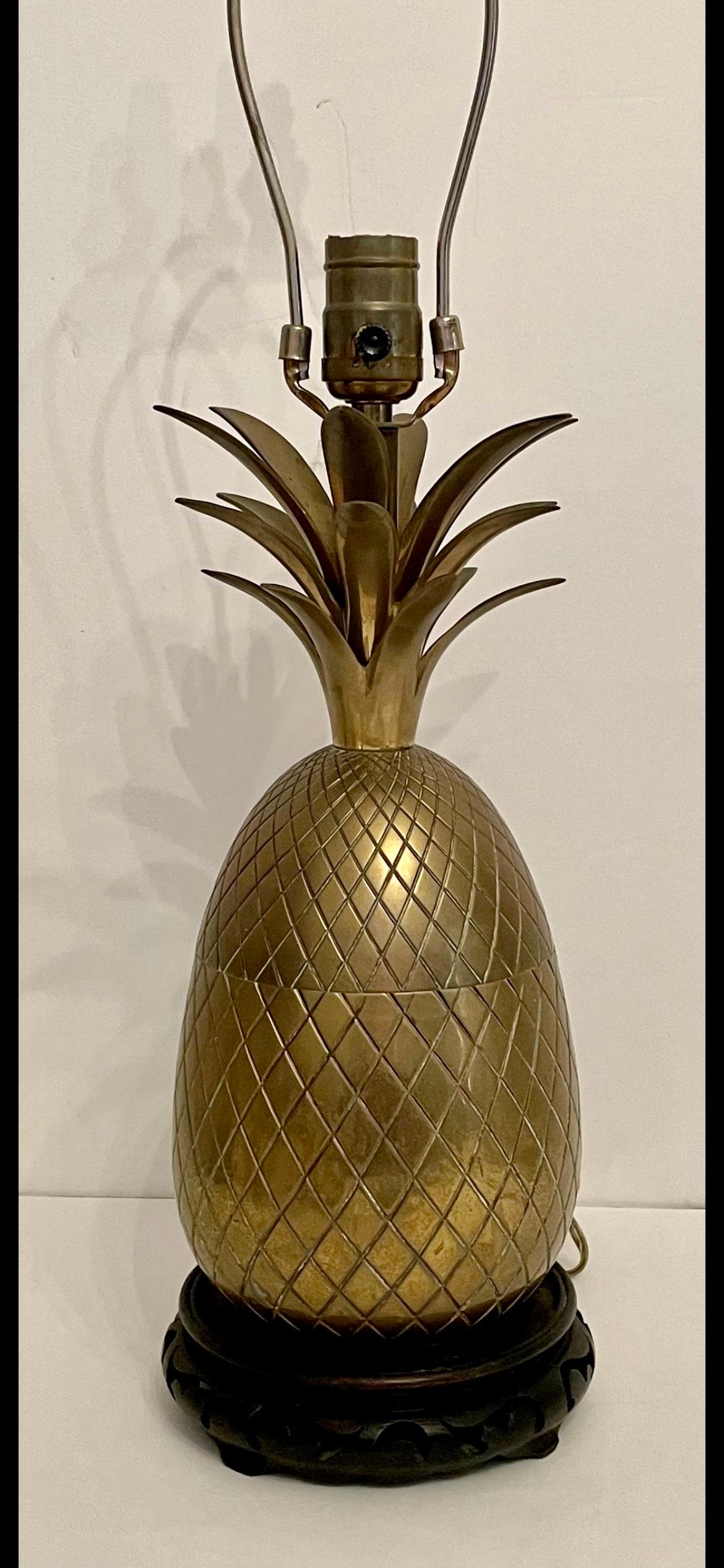 Italian brass pineapple lamp on carved wood base. Good original condition, patina from age and use. Good overall condition. Measures 24