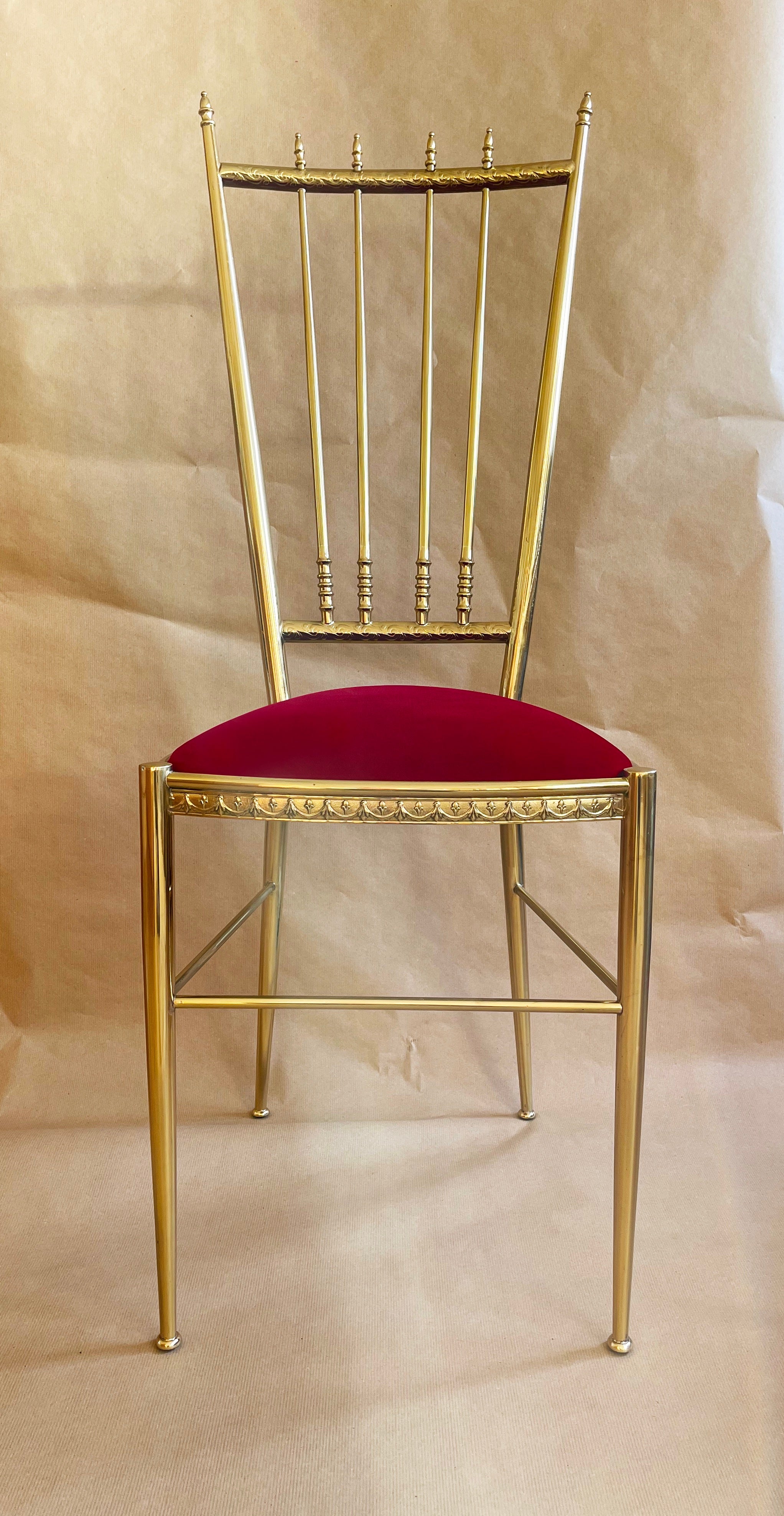 Impressive original 1960s to 1970s side chair or vanity chair made from brass. 
Features a juicy red velvet seat.
Quite unusual and beautiful composition of high end materials & craftsmanship indeed.
Made in Italy by unknown maker to the highest