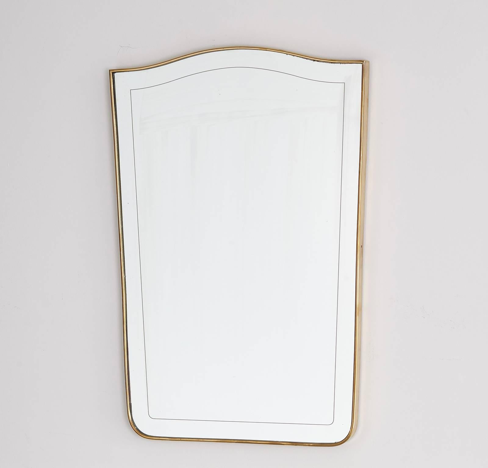 Gorgeous Italian brass mirror with elegant curves and subtle etching around perimeter of mirror. Perfect for a chic bathroom or entry.
