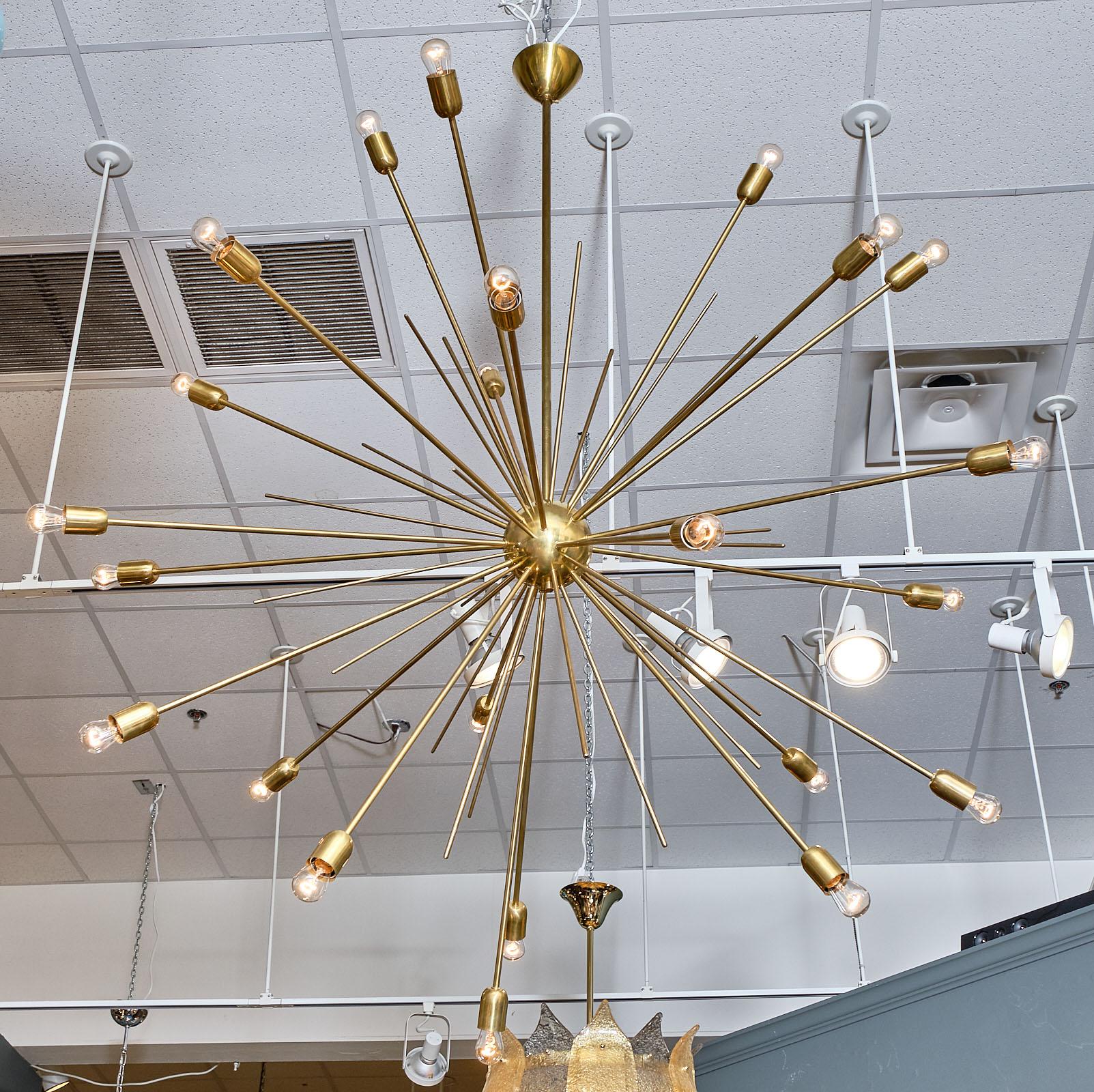 Italian brass Sputnik chandelier with multiple stems; each featuring an oblong gilt brass socket. The central sphere is brass as well and this fixture has been newly wired to fit US standards.