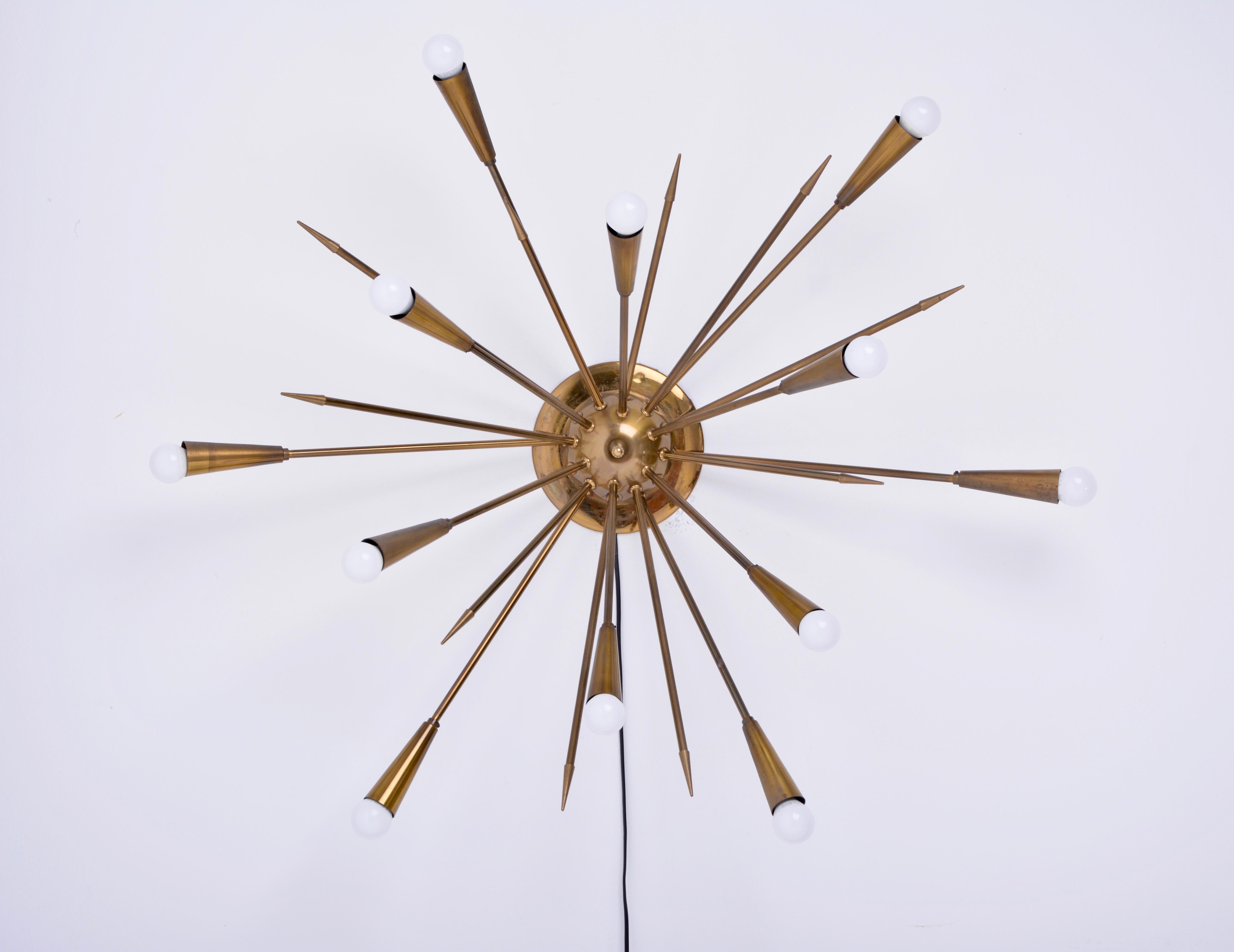 Sputnik lamp in the style of Stilnovo, produced in the 1950s in Italy. The lamp features 12 arms with lights and 12 arms in form of arrows, very good condition.