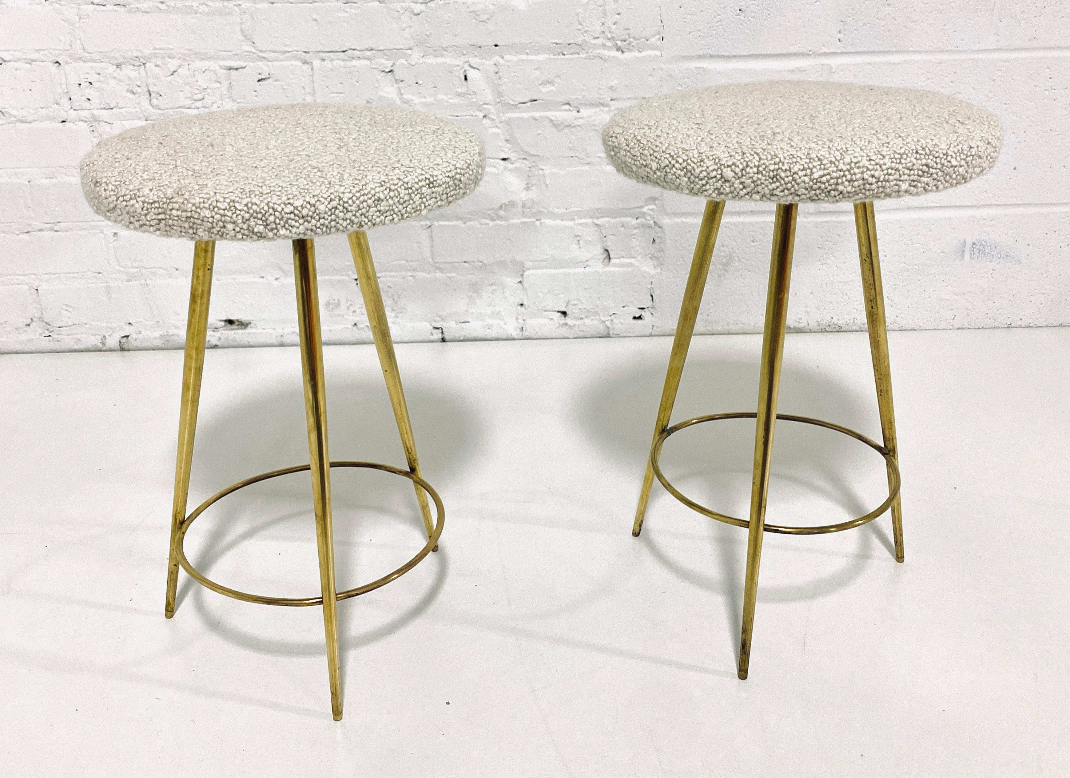 Chic low brass stools with cream boucle upholstery, Italian, circa 1950.
