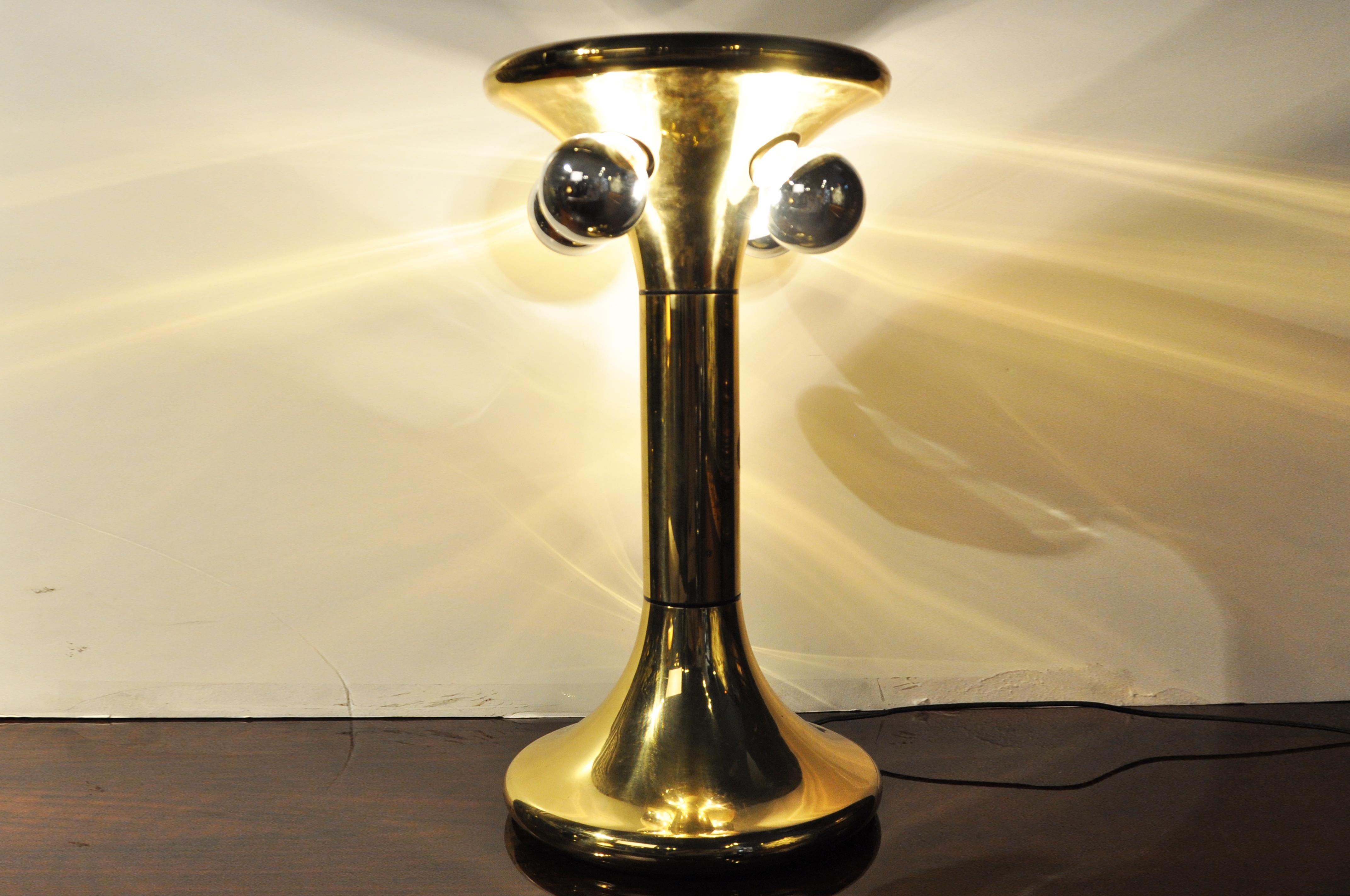 This dramatic table lamp is from Milan, Italy and was made from brass and dates to about 1960. The lamp utilizes four chrome dome bulbs and has been rewired for use in the U.S. Wear consistent with age and use.
 